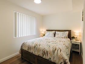 A queen bed situated on the lower storey. The room also contains a built in robe