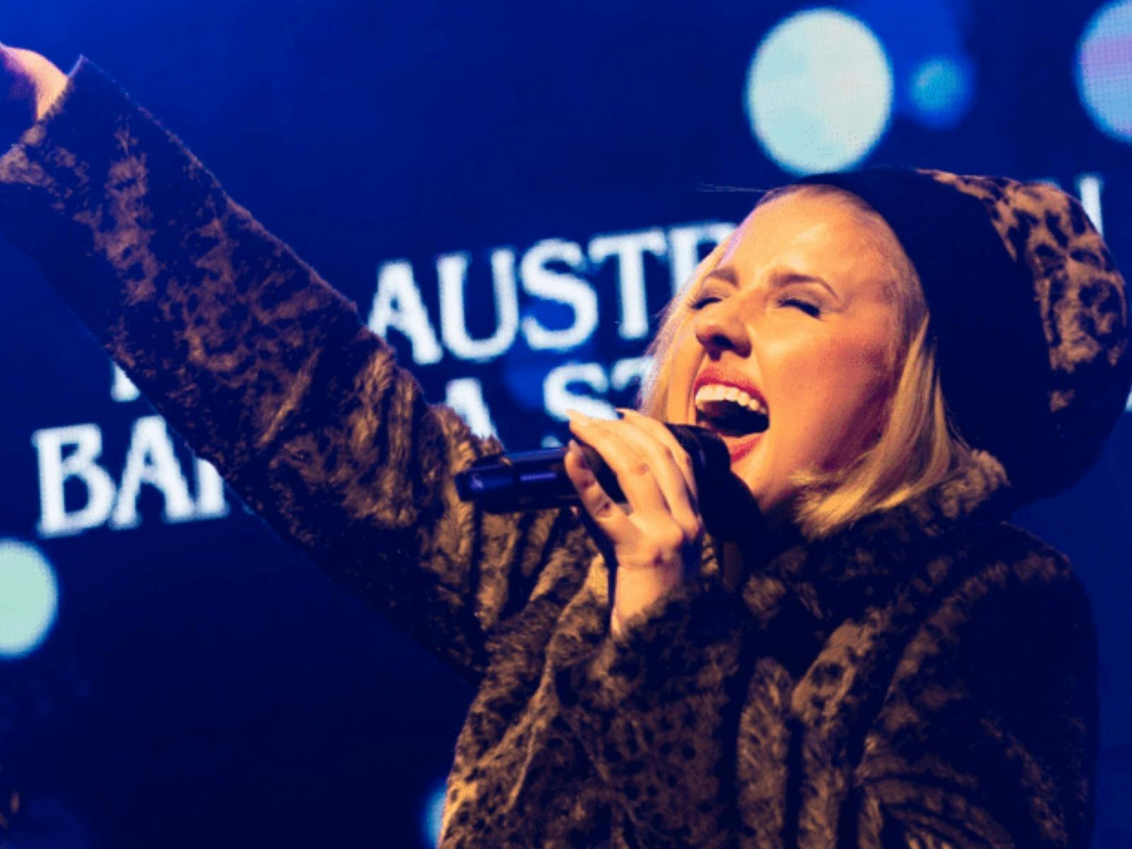 A person singing on stage