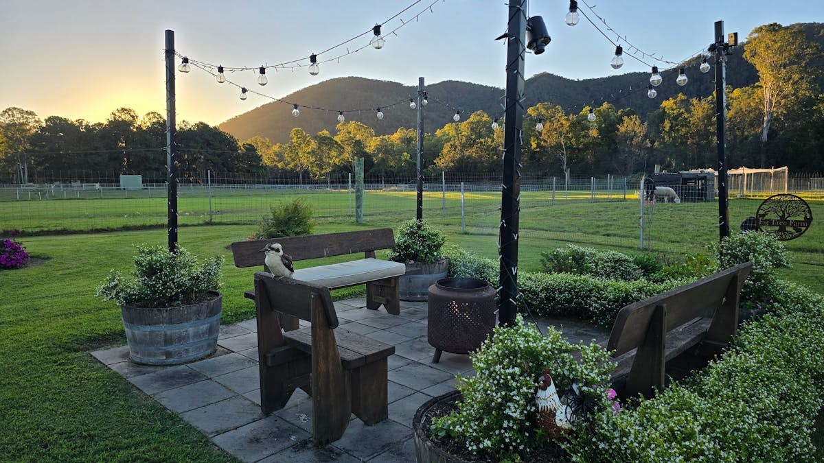 Toast marshmallows over the outdoor fire pit that is lit with fairy lights. Wood is provided.