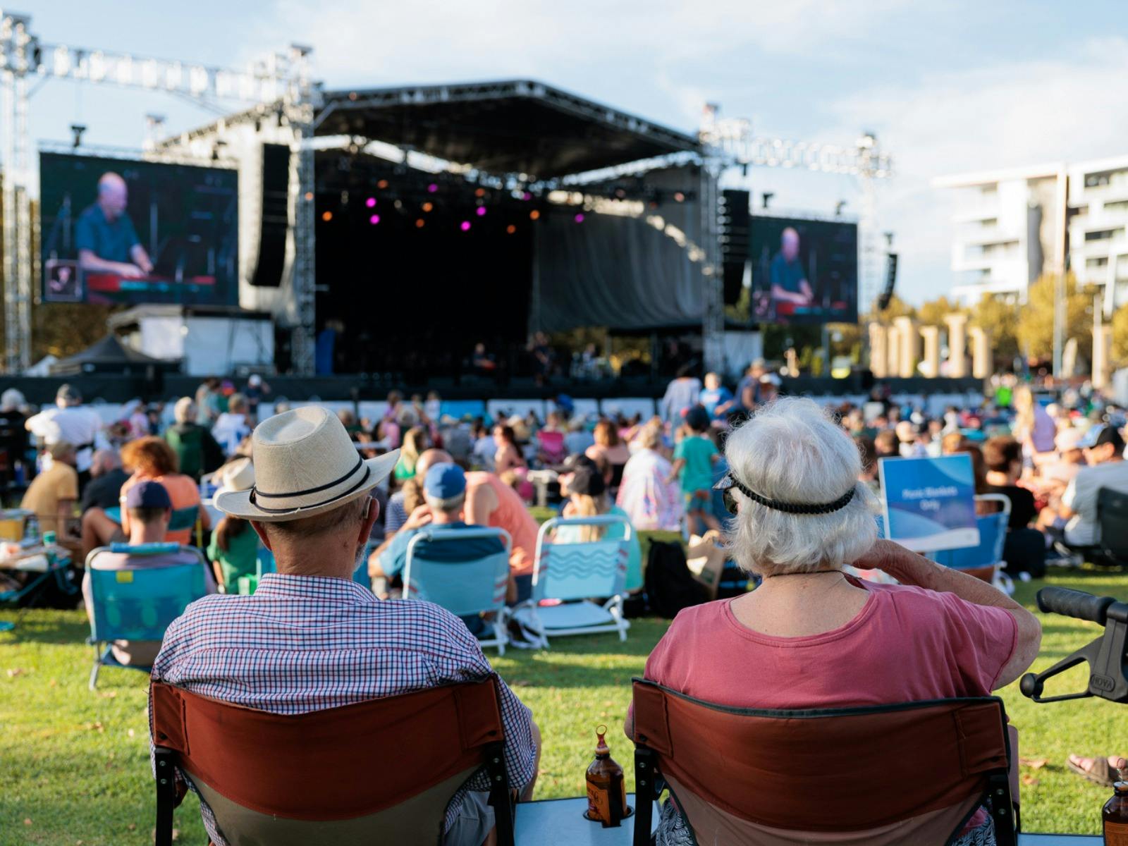 The back of an elderly couple looking towards the stage