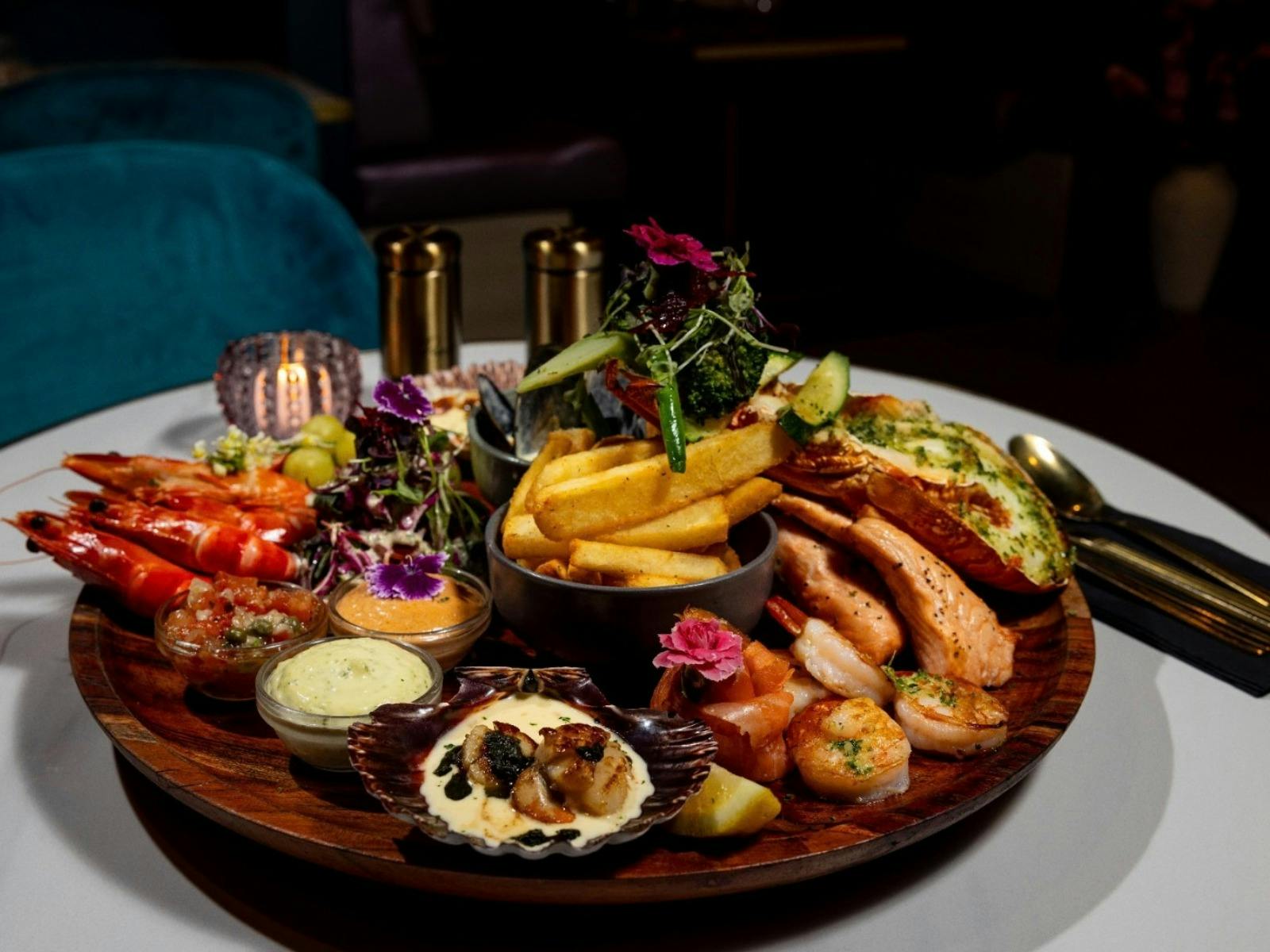 Generous seafood platter featuring lobster, scallops, prawns, fish and chips, beautifully presented