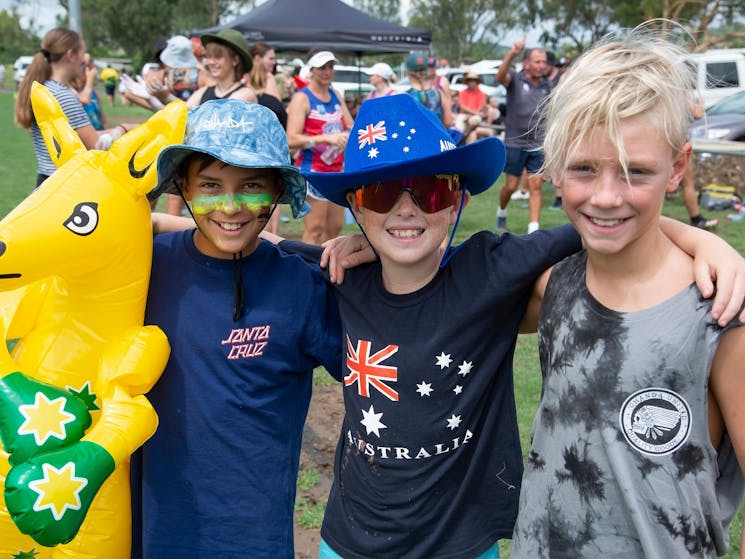three boys, two with hats and blow up kangaroo