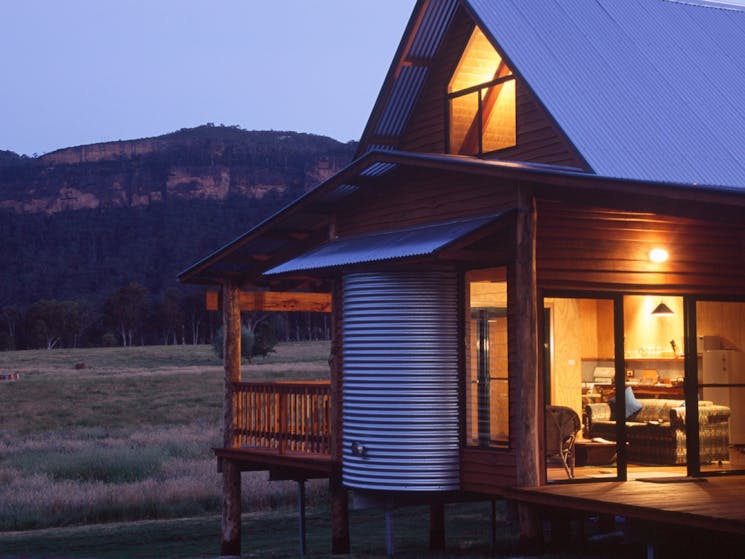 Cosy cabin at sunset with view of mountains