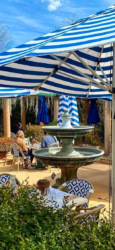 An outdoor cafe with large umbrellas to provide shade