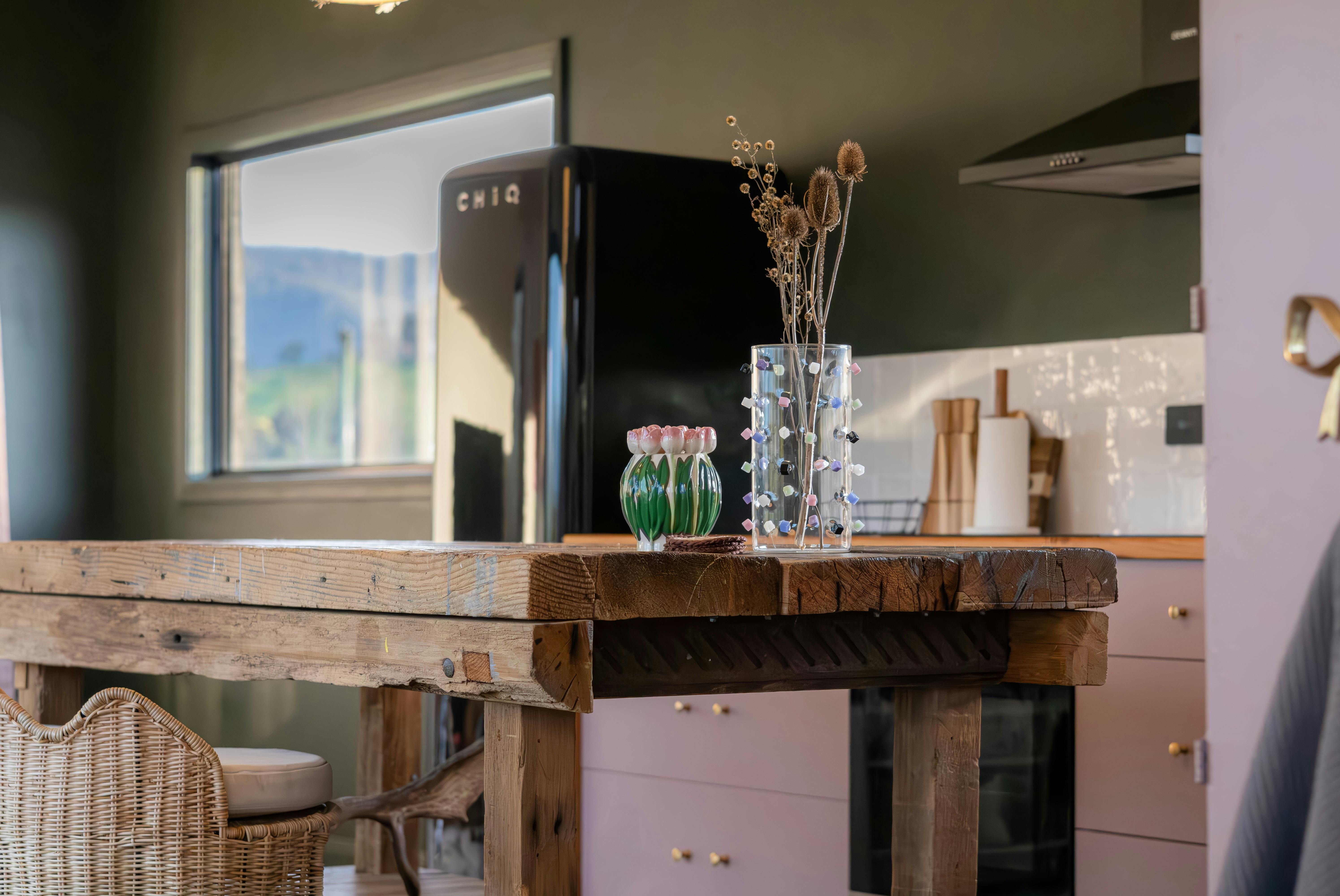 Soft pink kitchen at Tiers Rest featuring stylish, modern appliances and thoughtful design details