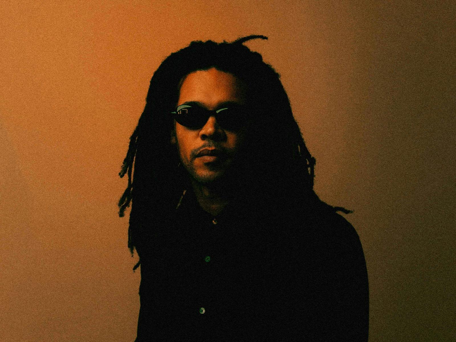 Artist Bradley Zero staring at camera with sunglasses on
