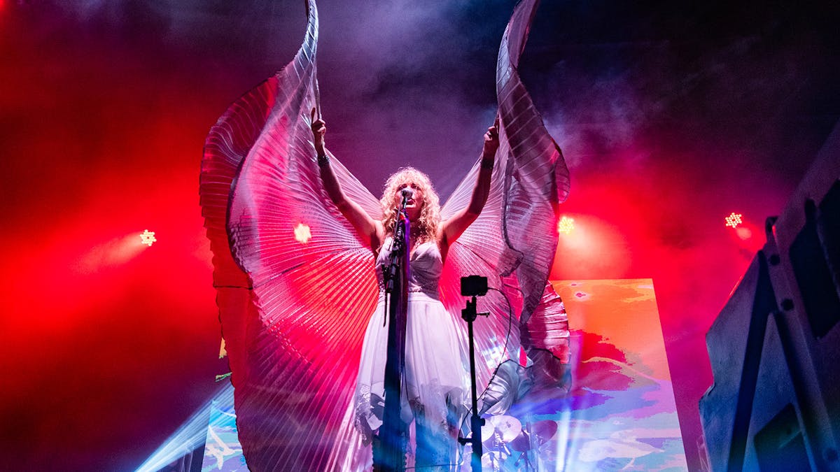 Former Dreams Show members performing Fleetwood Mac hits onstage with full crowd energy.
