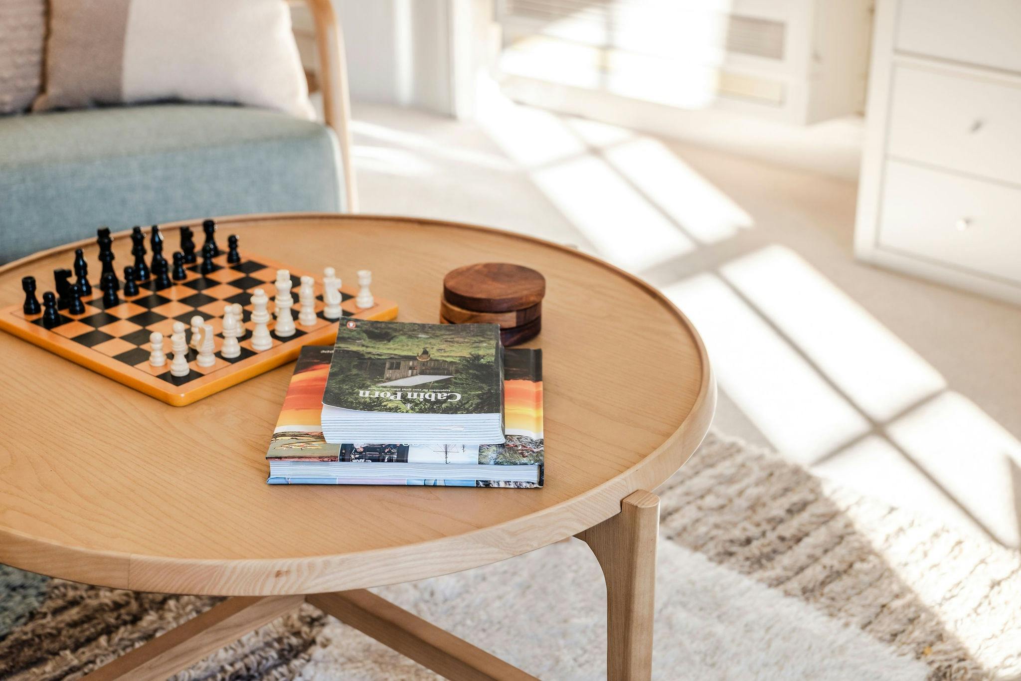 Coffee table in living area with chess board and coffee table books