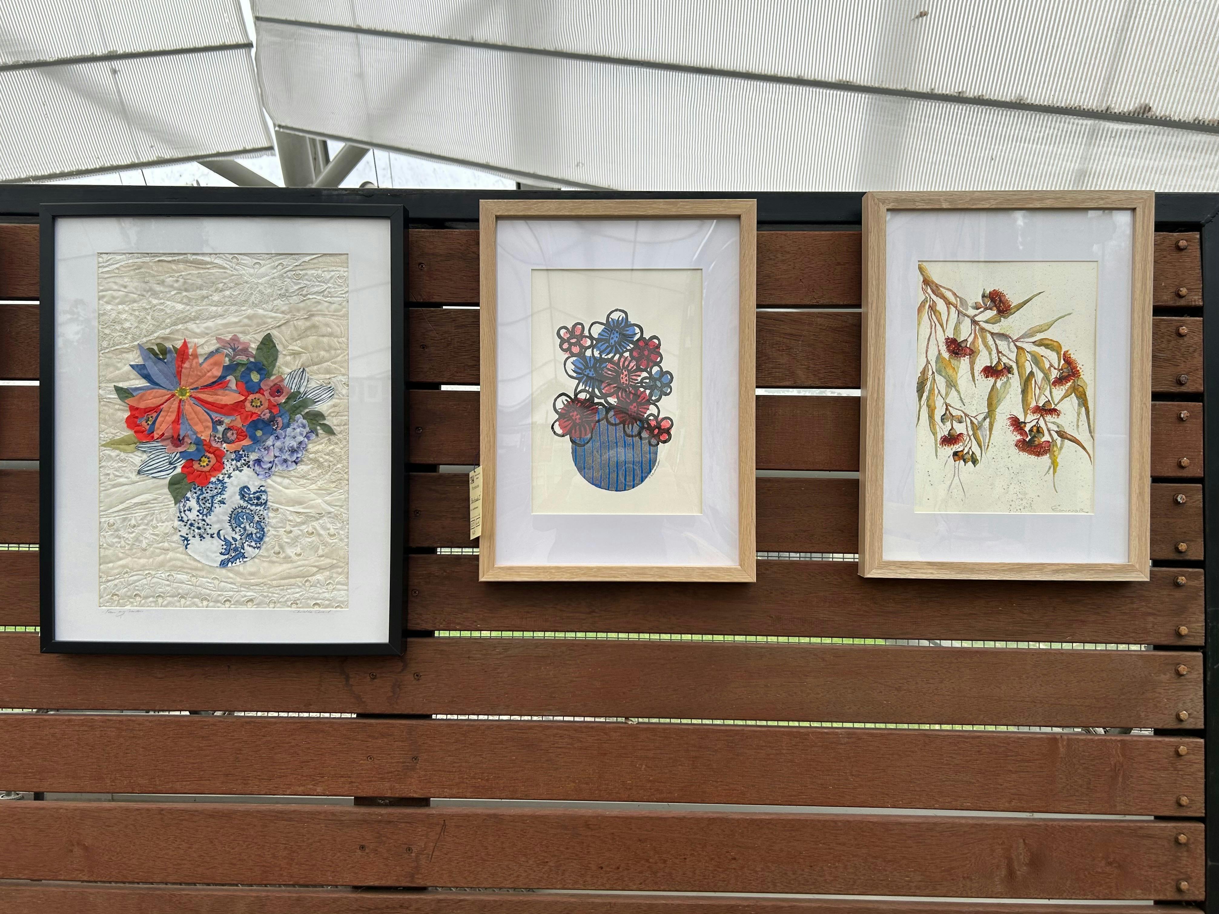 Floral Artworks on display against a wooden background