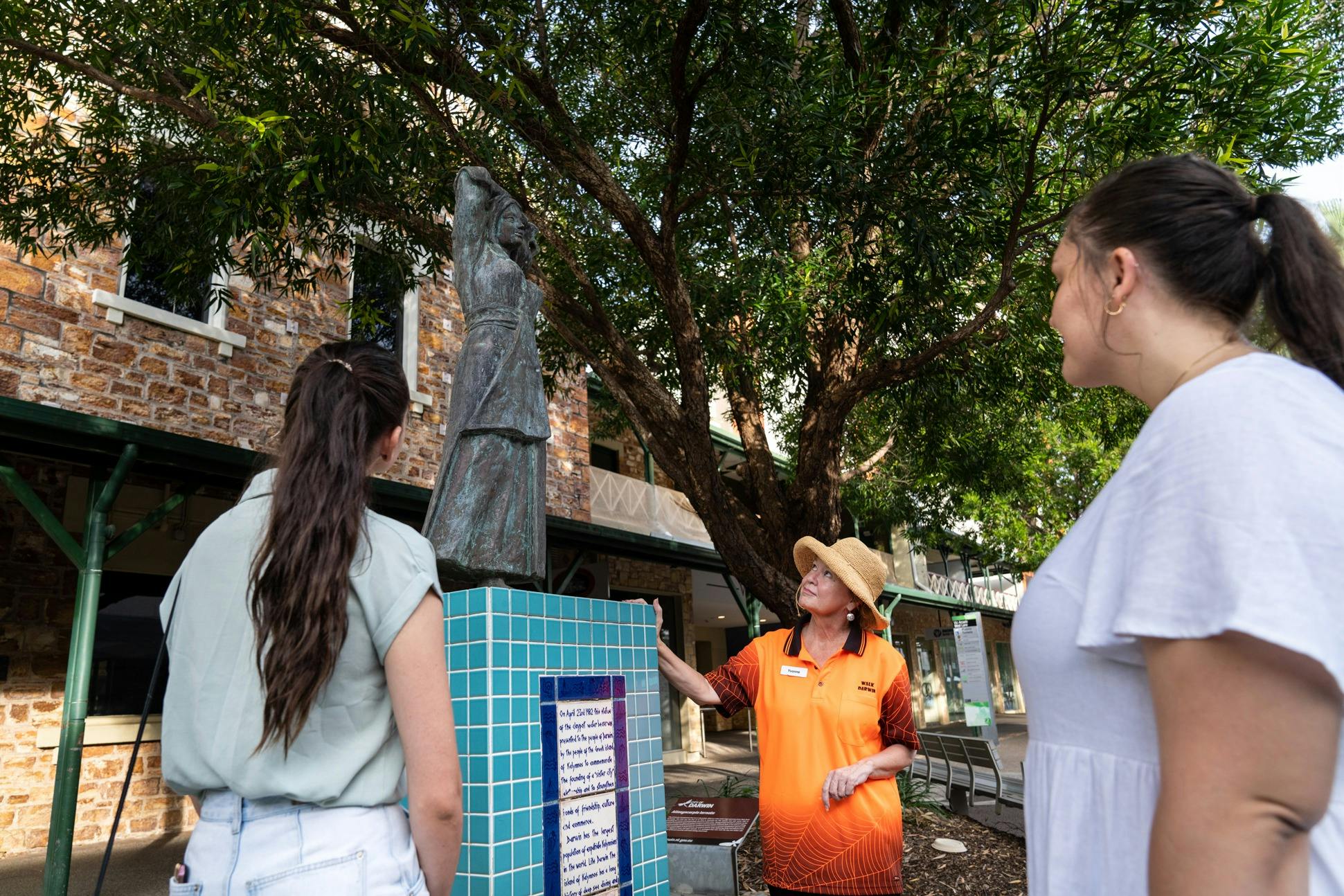 Guide interprets the Greek Water Bearer statue for guests