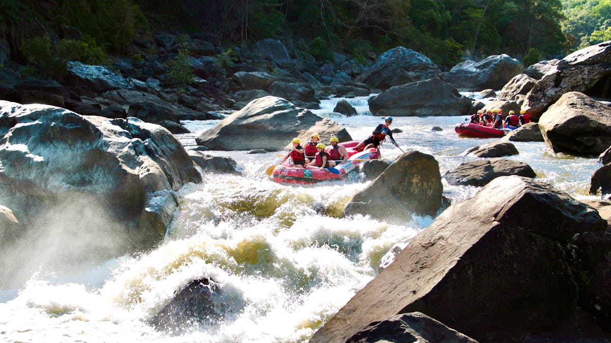 Wide Scenic Shot of two Rafting boats approaching the rooster tail rapid on the Barron River