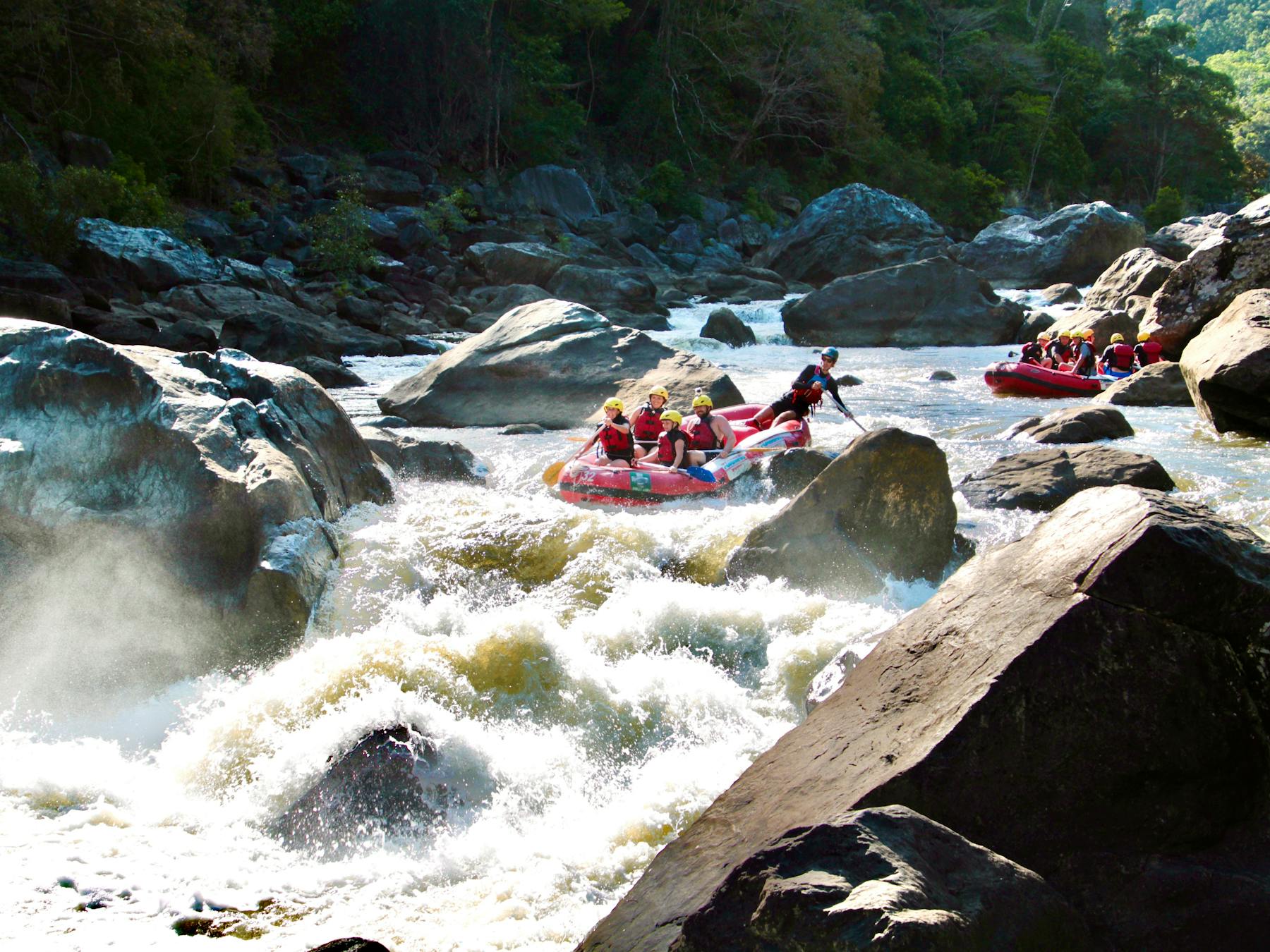 Wide Scenic Shot of two Rafting boats approaching the rooster tail rapid on the Barron River