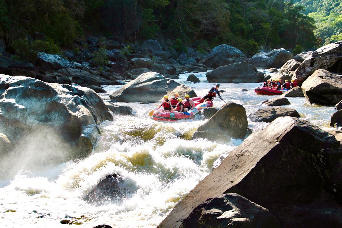 Wide Scenic Shot of two Rafting boats approaching the rooster tail rapid on the Barron River