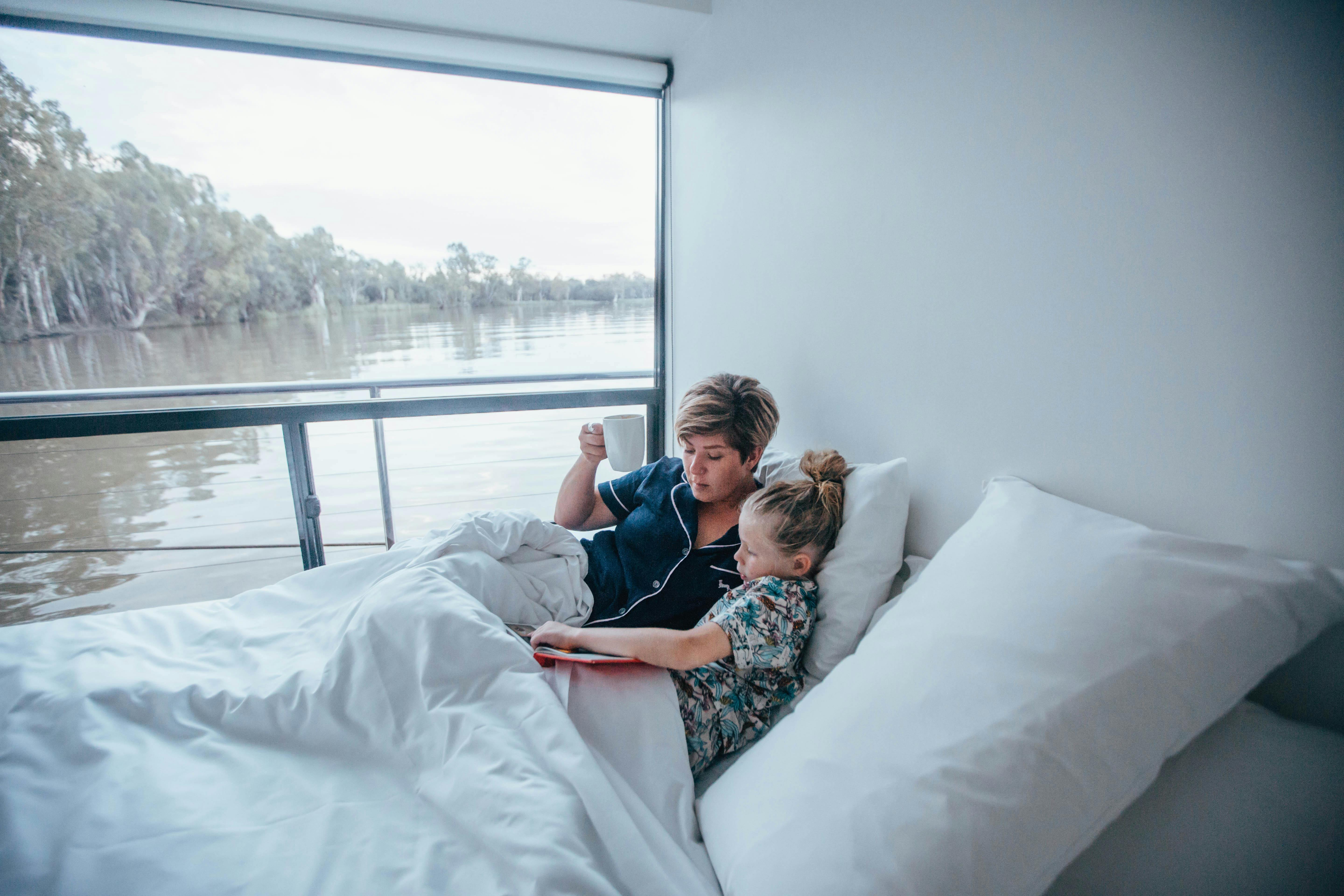 Mum and daughter waking up slowly onboard a houseboat