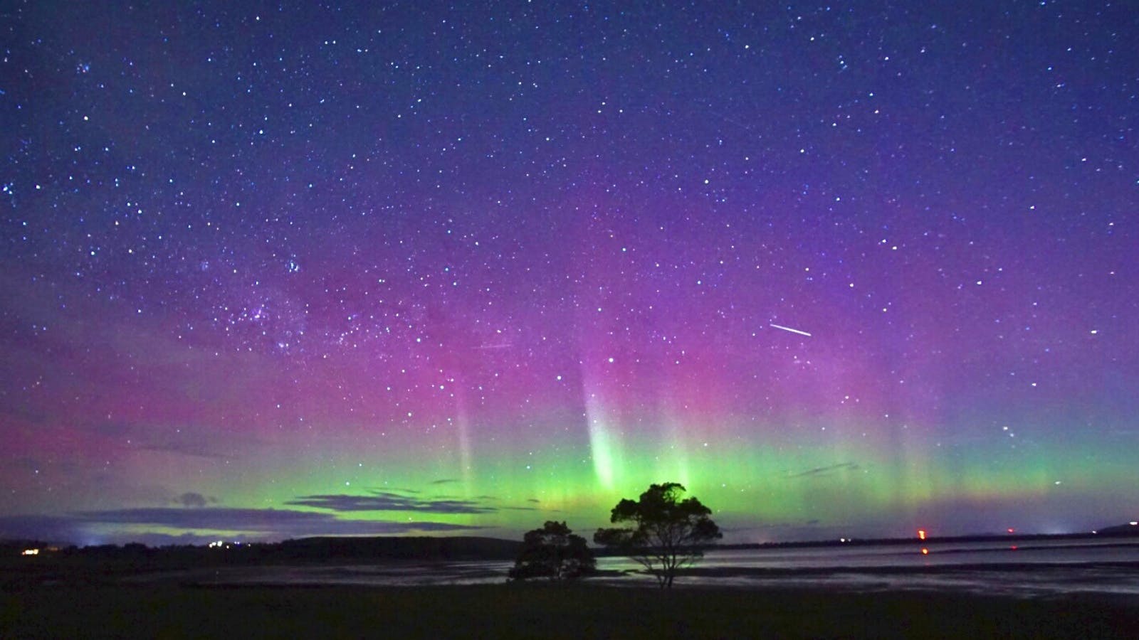Aurora glowing above Iron Creek Bay Estate on a clear Tasmanian night.