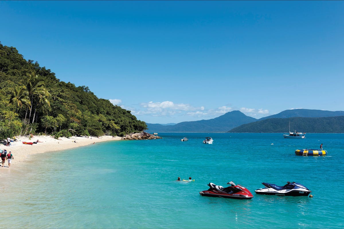 Rainforest slopes meet the ebach at Fitzroy Island