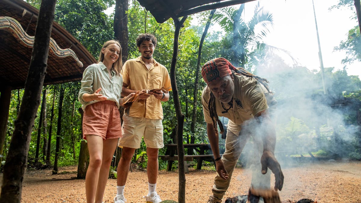 Two visitors participating at an Aboriginal traditional Welcome to Country and Smoking Ceremony