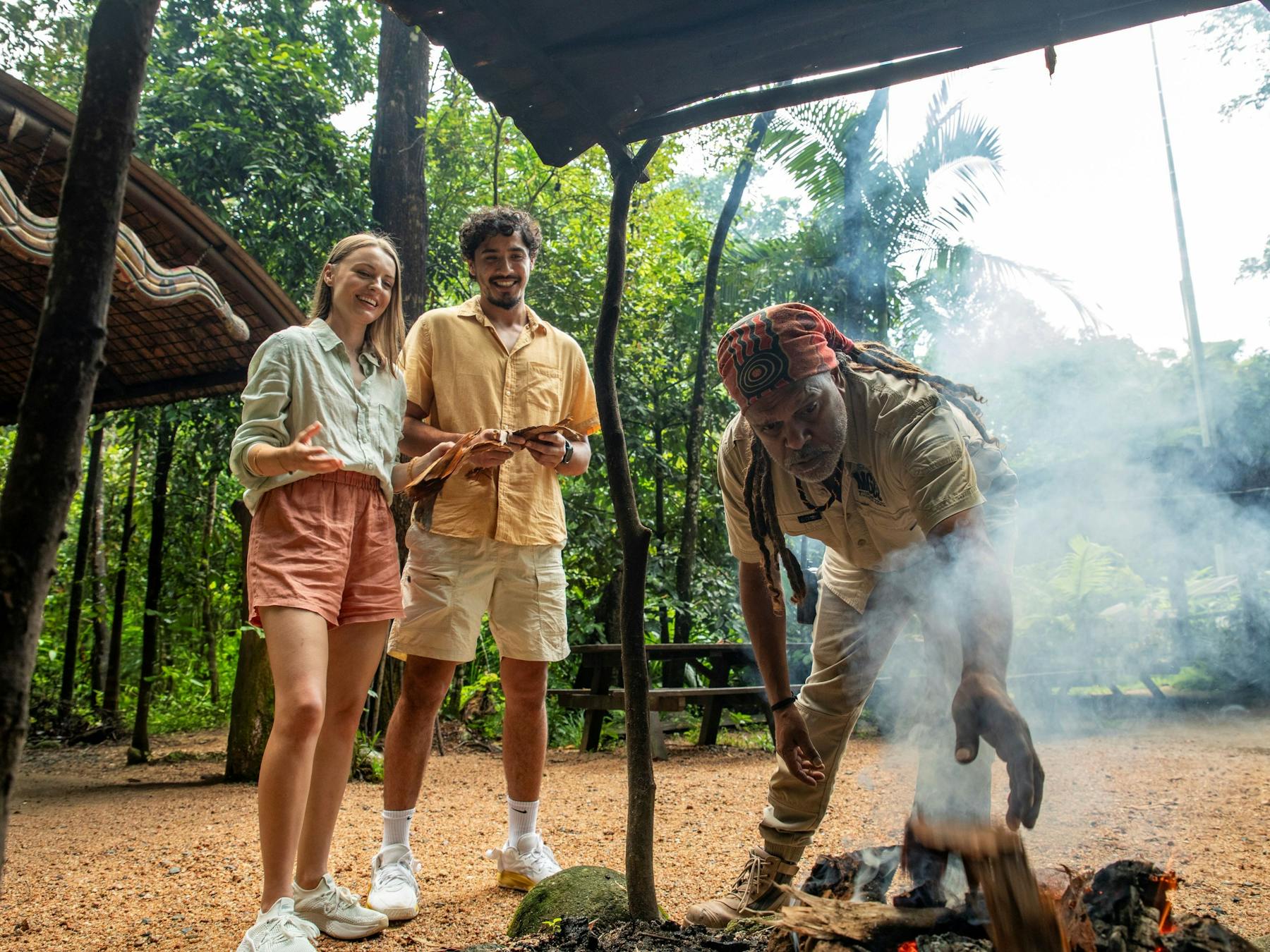 Two visitors participating at an Aboriginal traditional Welcome to Country and Smoking Ceremony