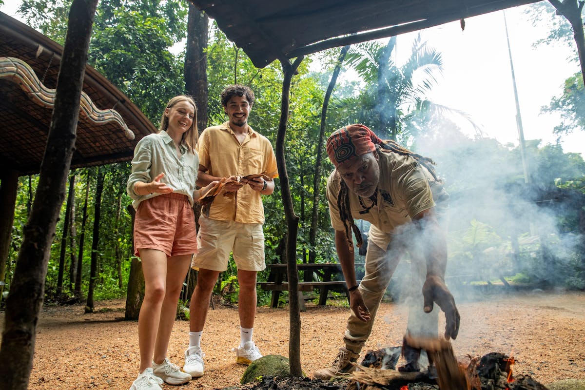 Two visitors participating at an Aboriginal traditional Welcome to Country and Smoking Ceremony