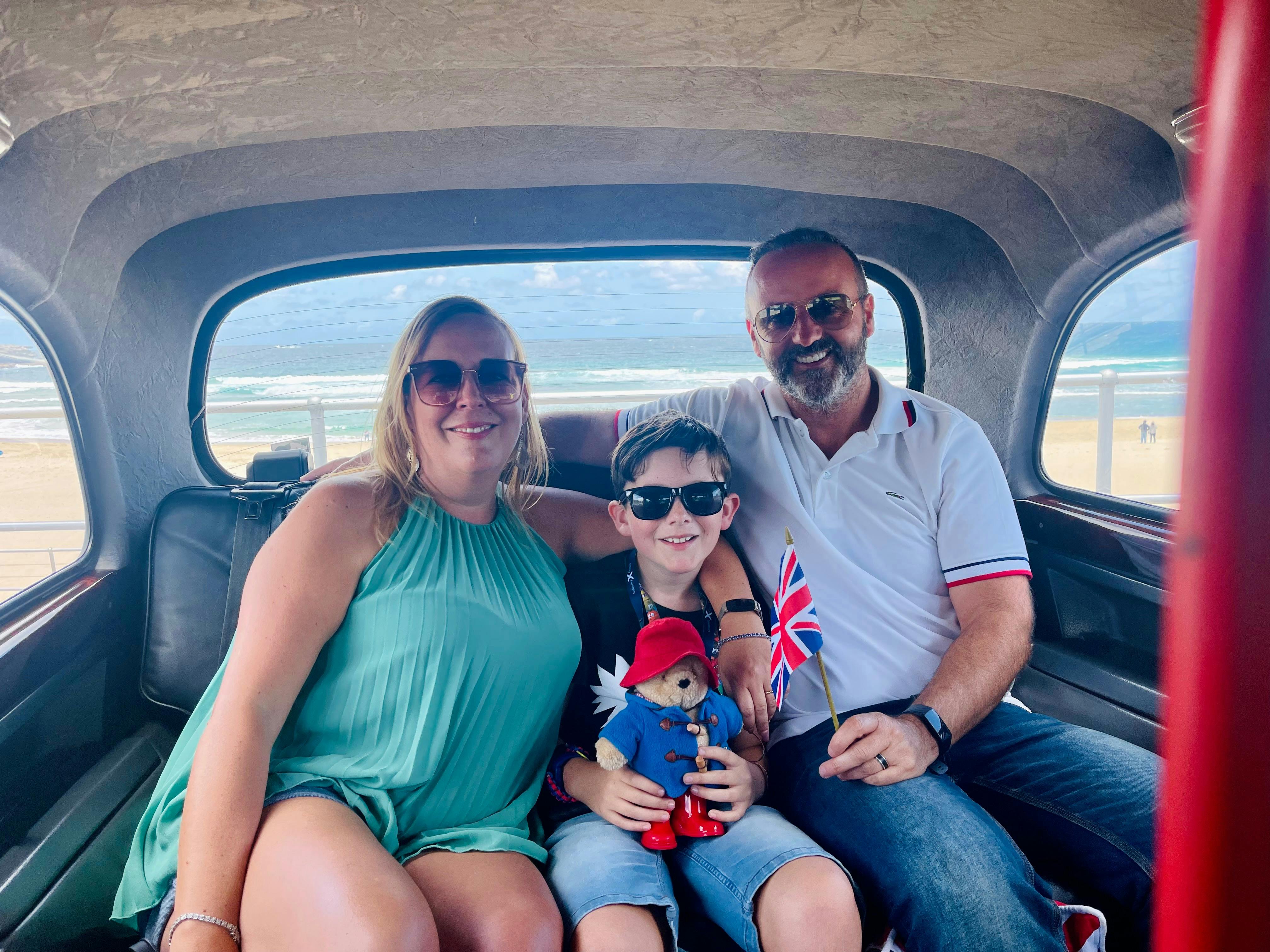 alt="Family enjoying a London cab experience in Sydney."