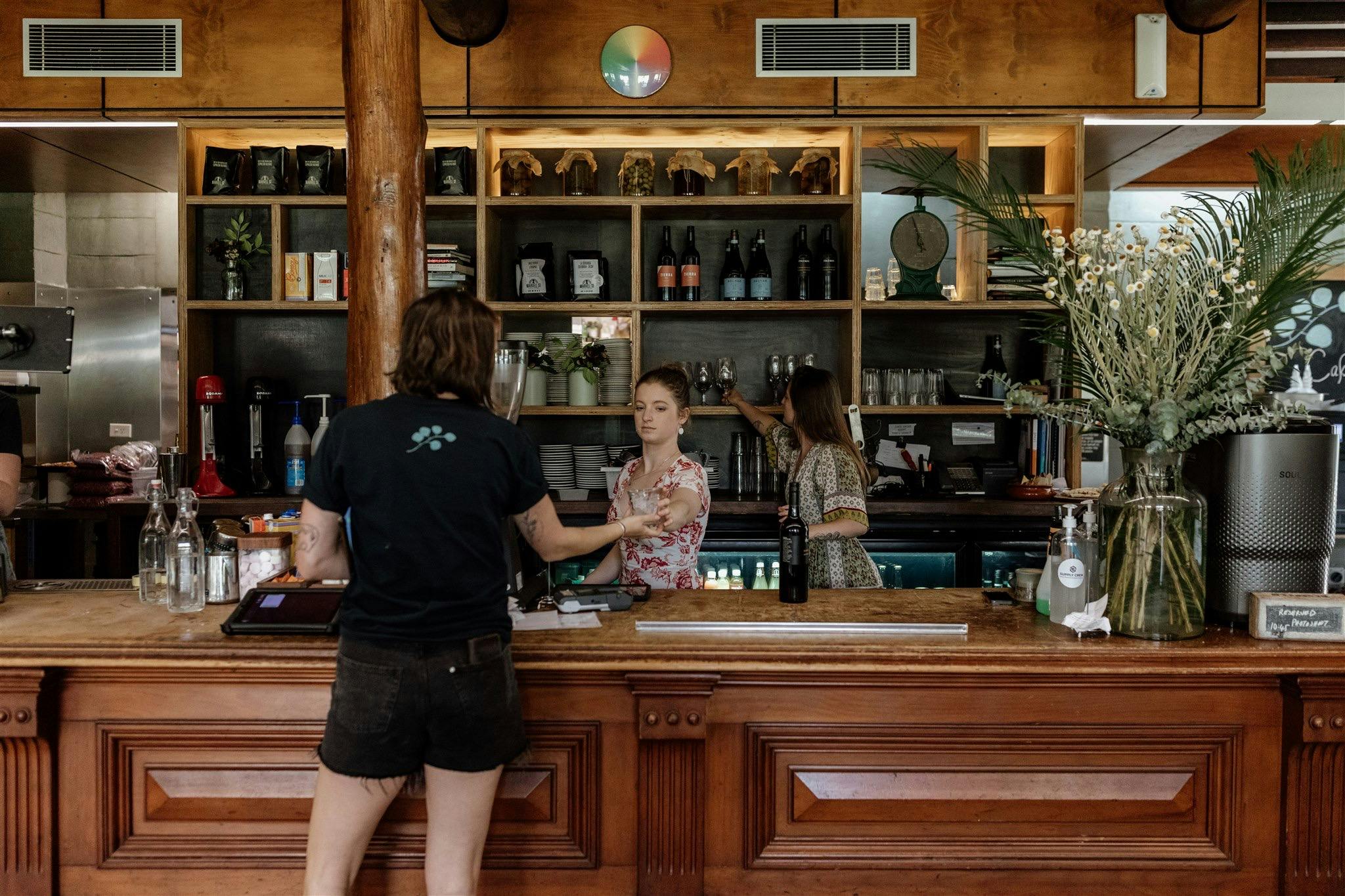 old timber bar and staff working inside cafe
