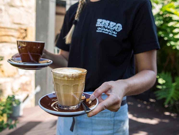 Waitress deliving morning coffees at Cafe Enzo, Pokolbin