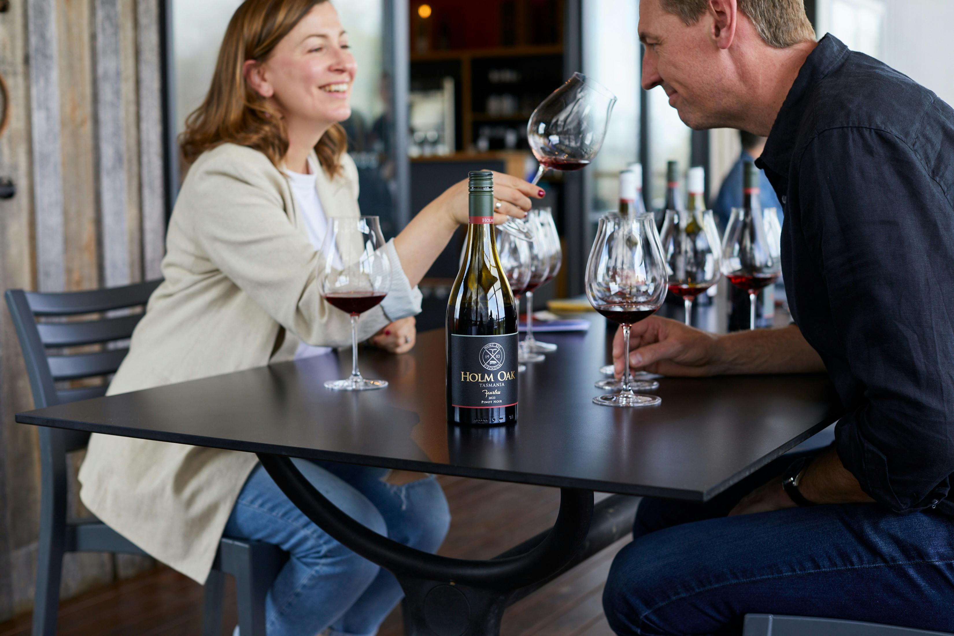 A man and a woman tasting wine