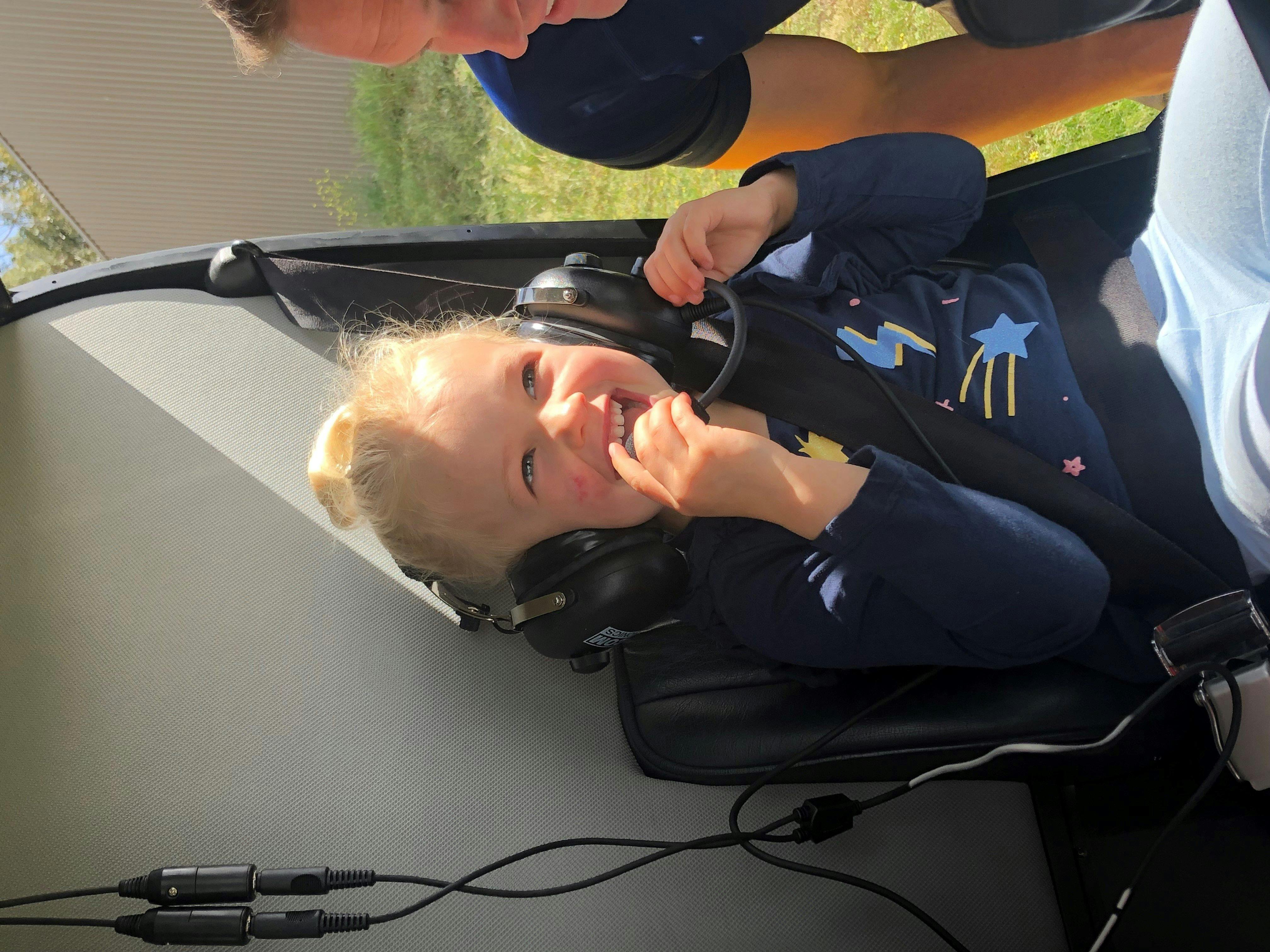 A little girl beyond excited to go in a  Helicopter
