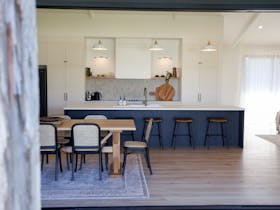 Open plan living and dining with double stacker sliding doors to outdoor entertaining area