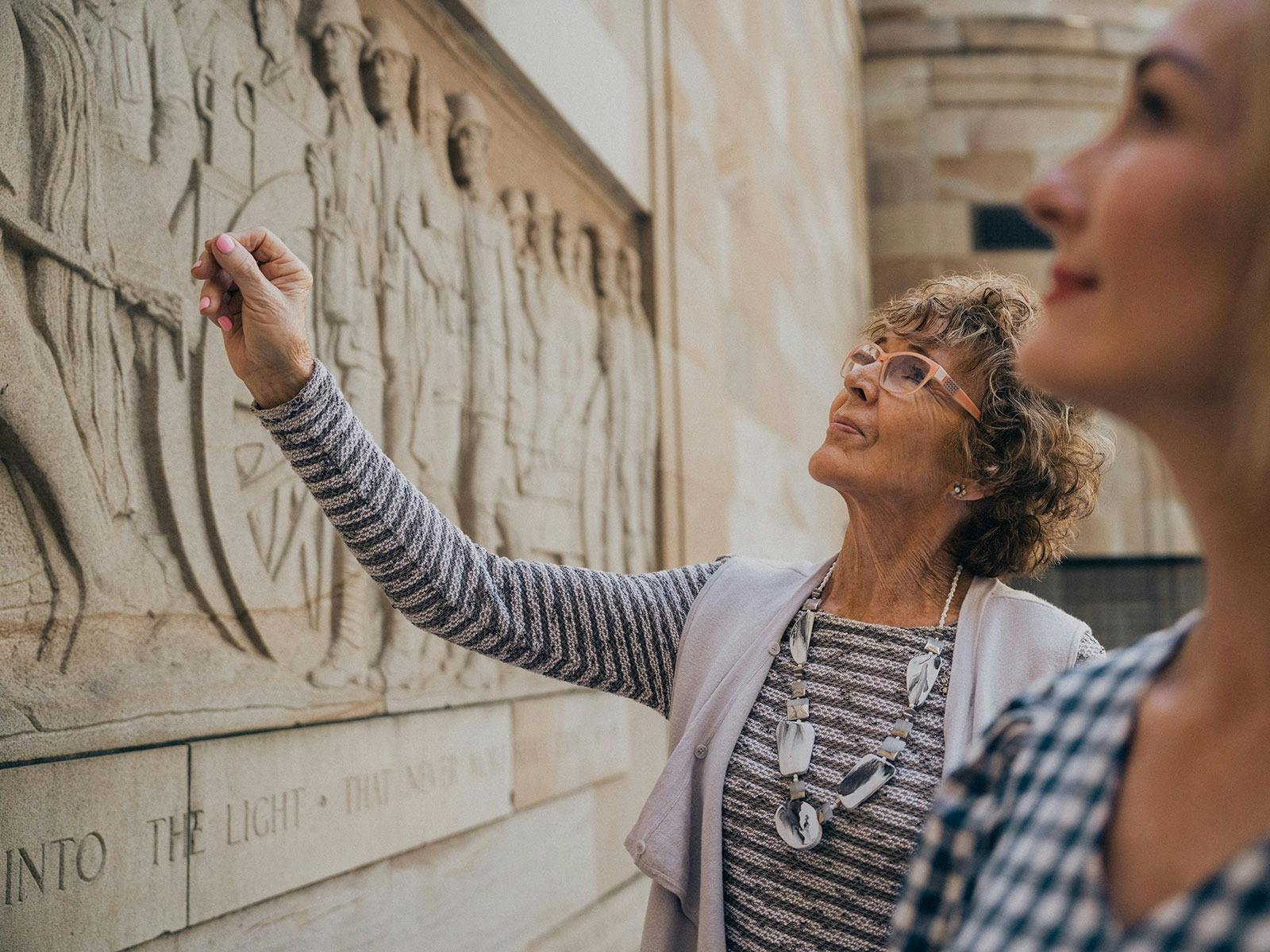 Mother and daughter admiring the Women's Memorial at Anzac Square parklands