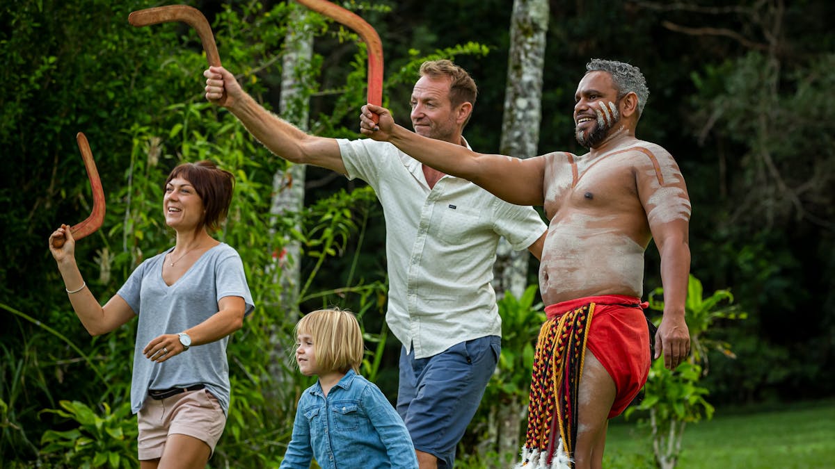 Family of three and an aboriginal guide throwing boomerang at Pamagirri Aboriginal Experiencei