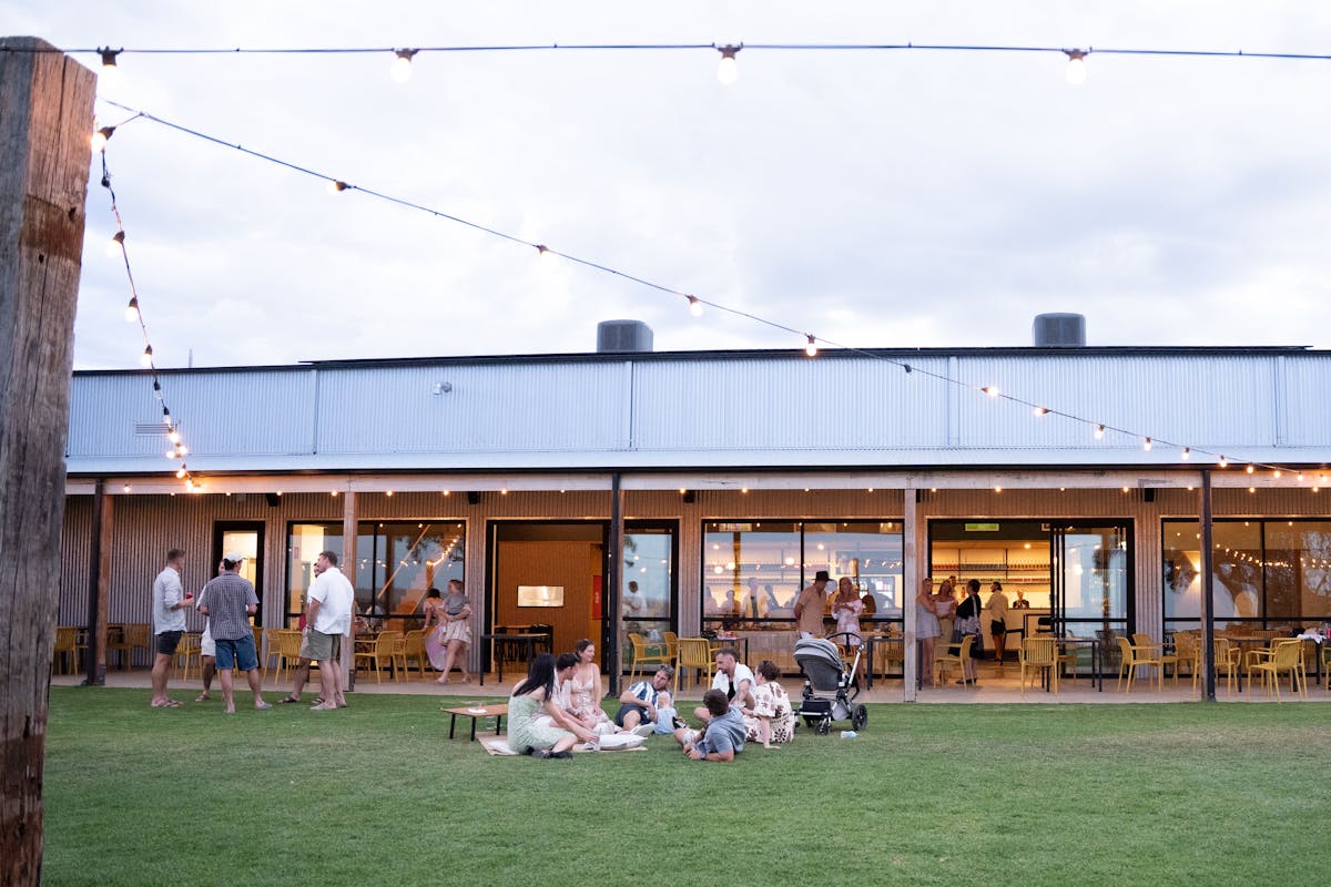 Fleurieu Gin Distillery outside dining with customers enjoying the lawn and picnic areas