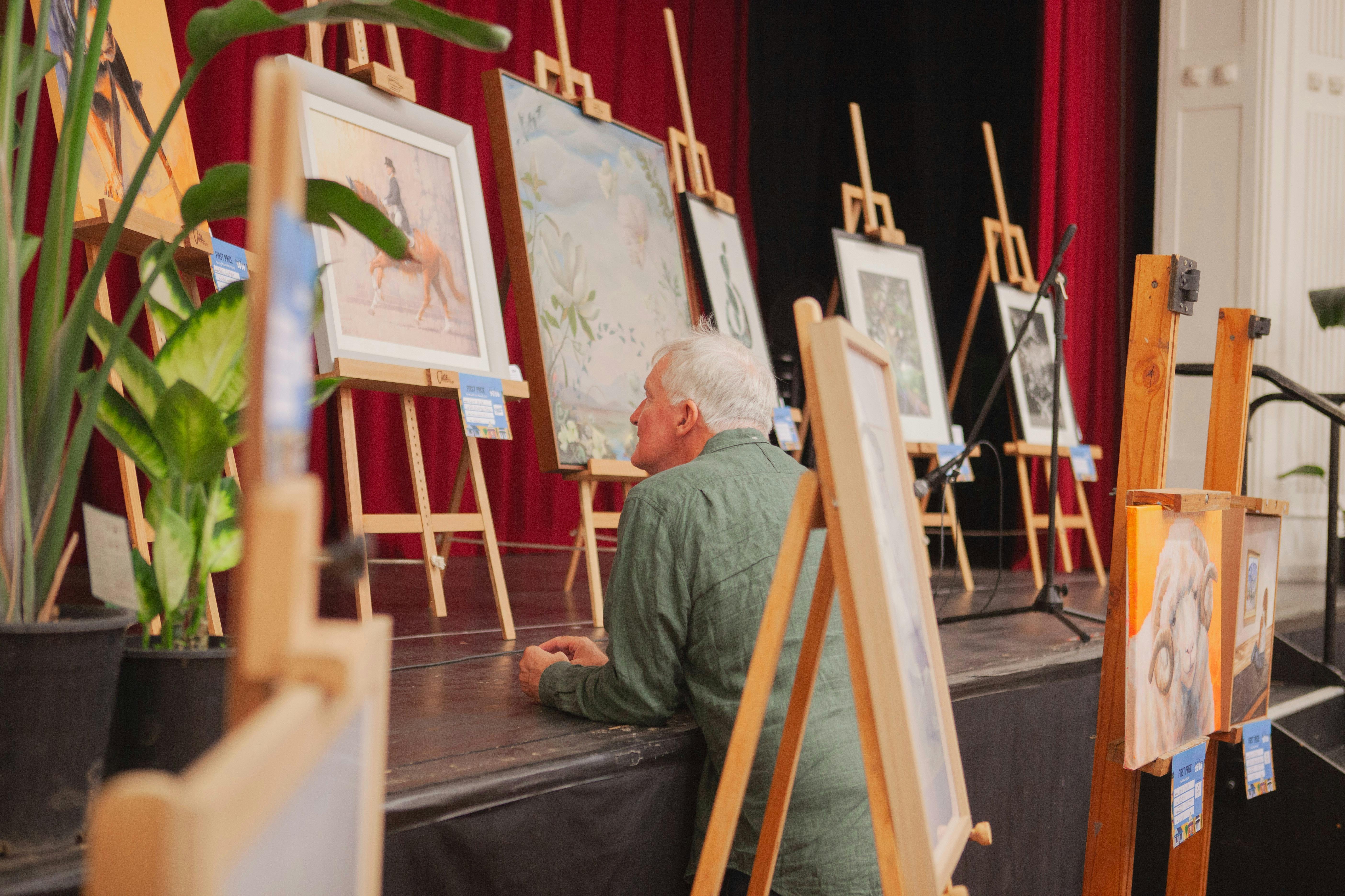 Man looking at the winning paintings
