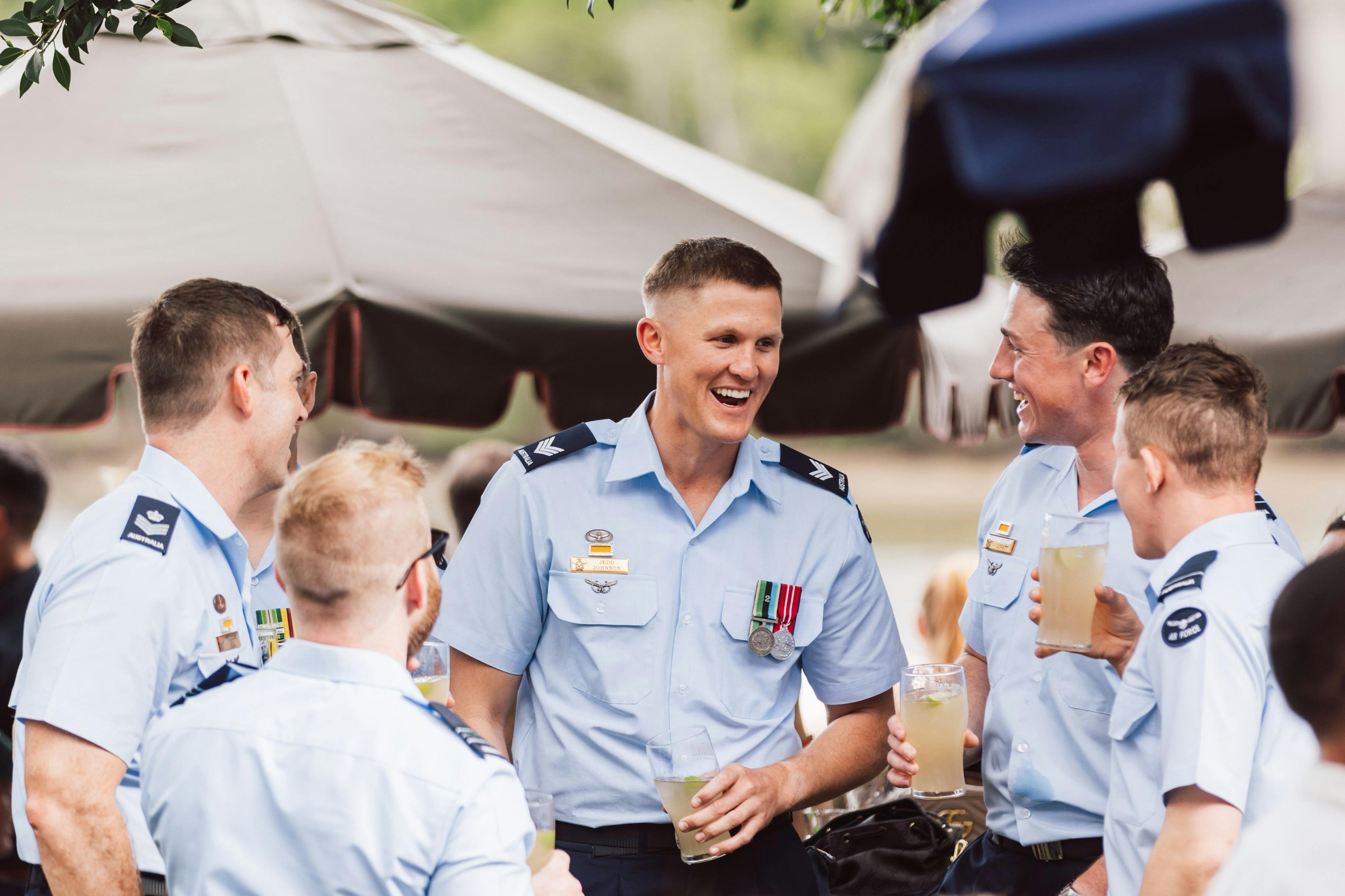 Five people share a laugh and a beverage at Howard Smith Wharves