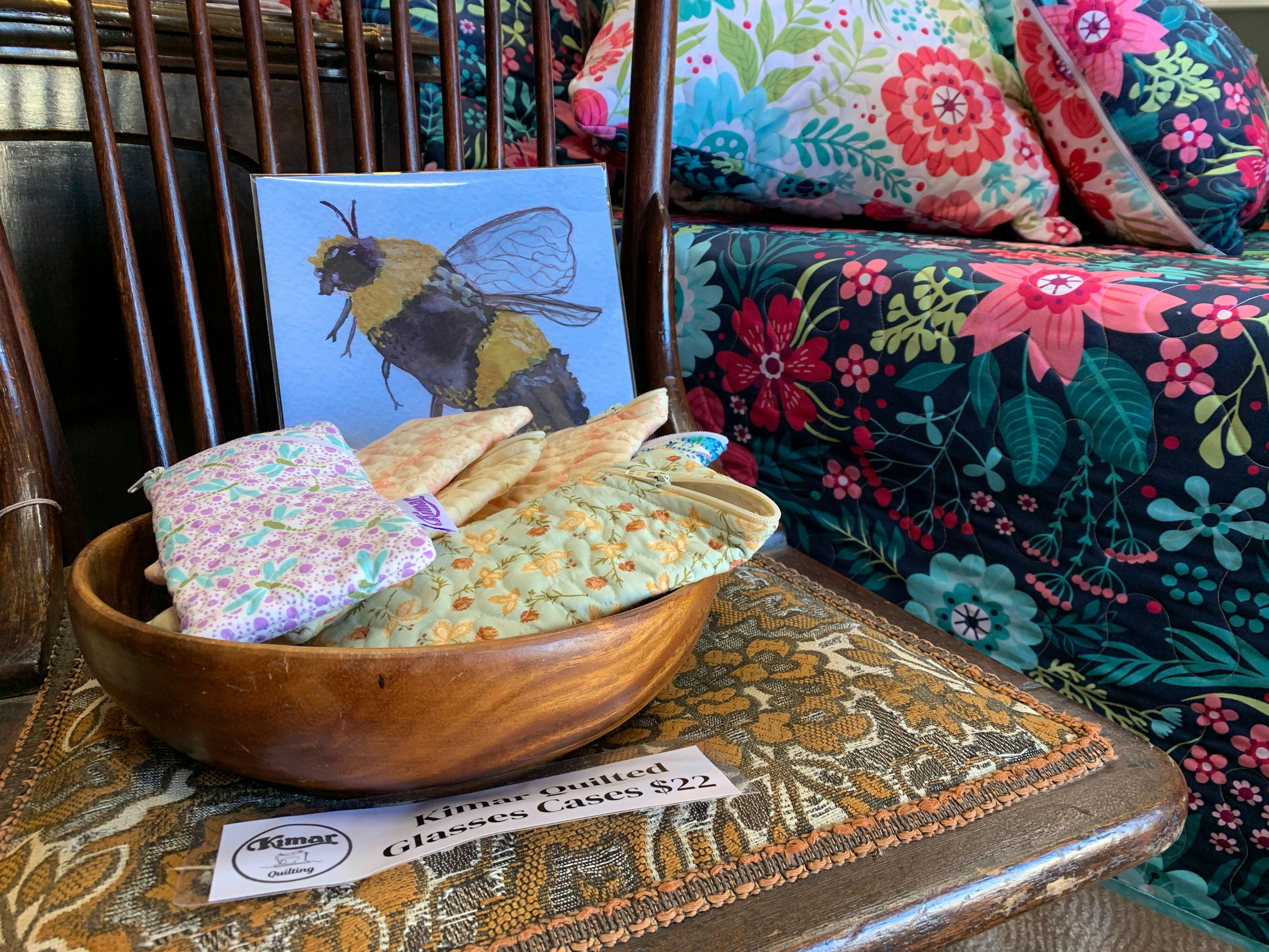 Kimar quilted glasses cases and quilts in the background