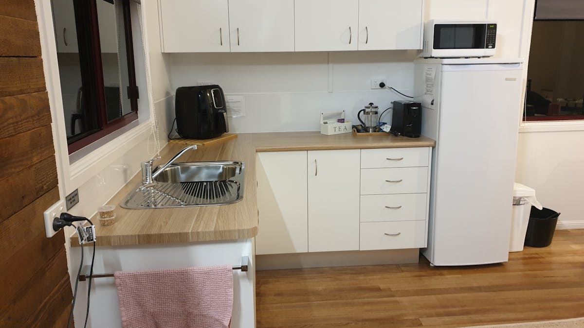 Full kitchenette complete with fridge, air fryer, kettle, microwave and all cooking utensils