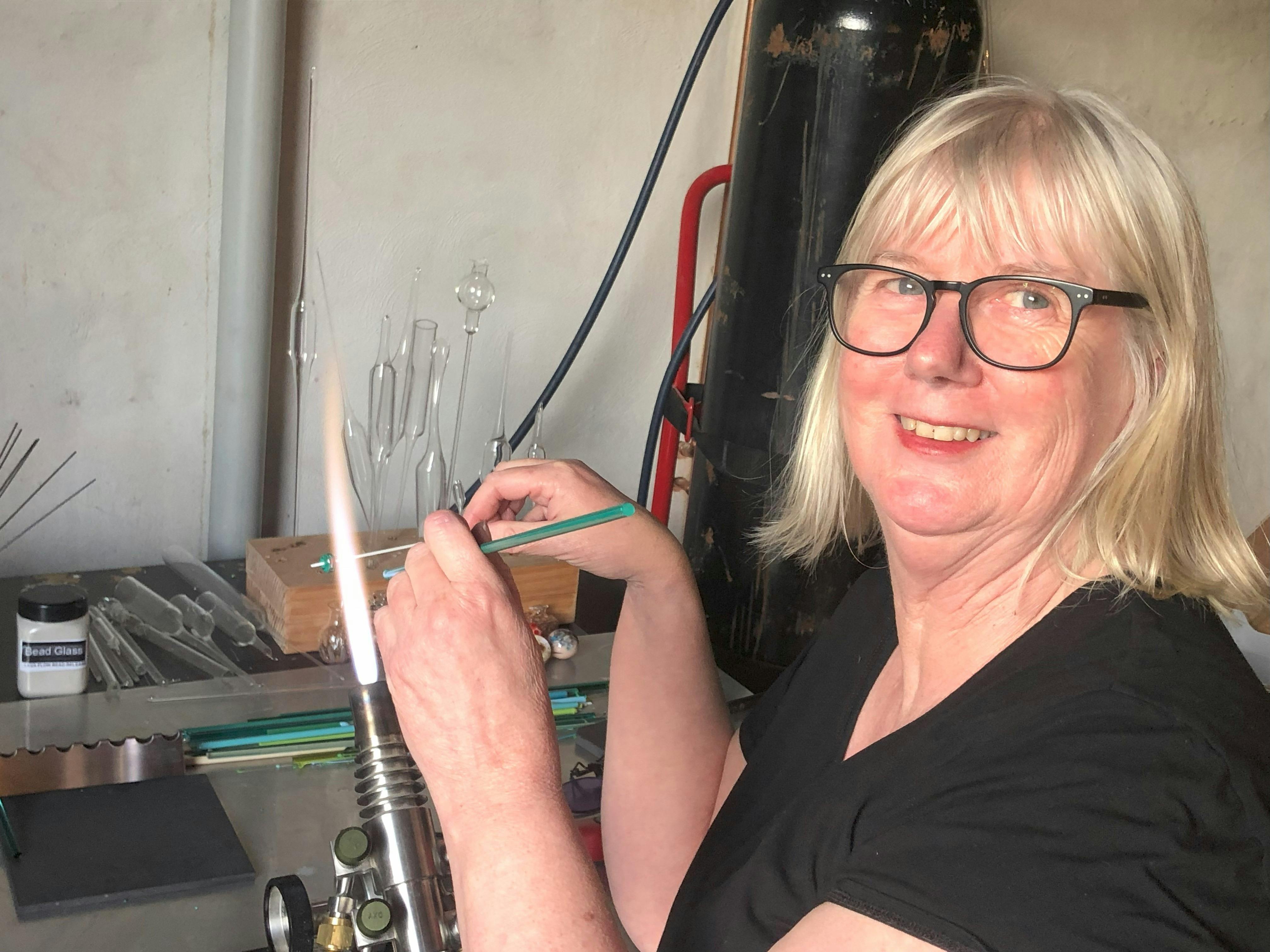 Catherine making a glass bead