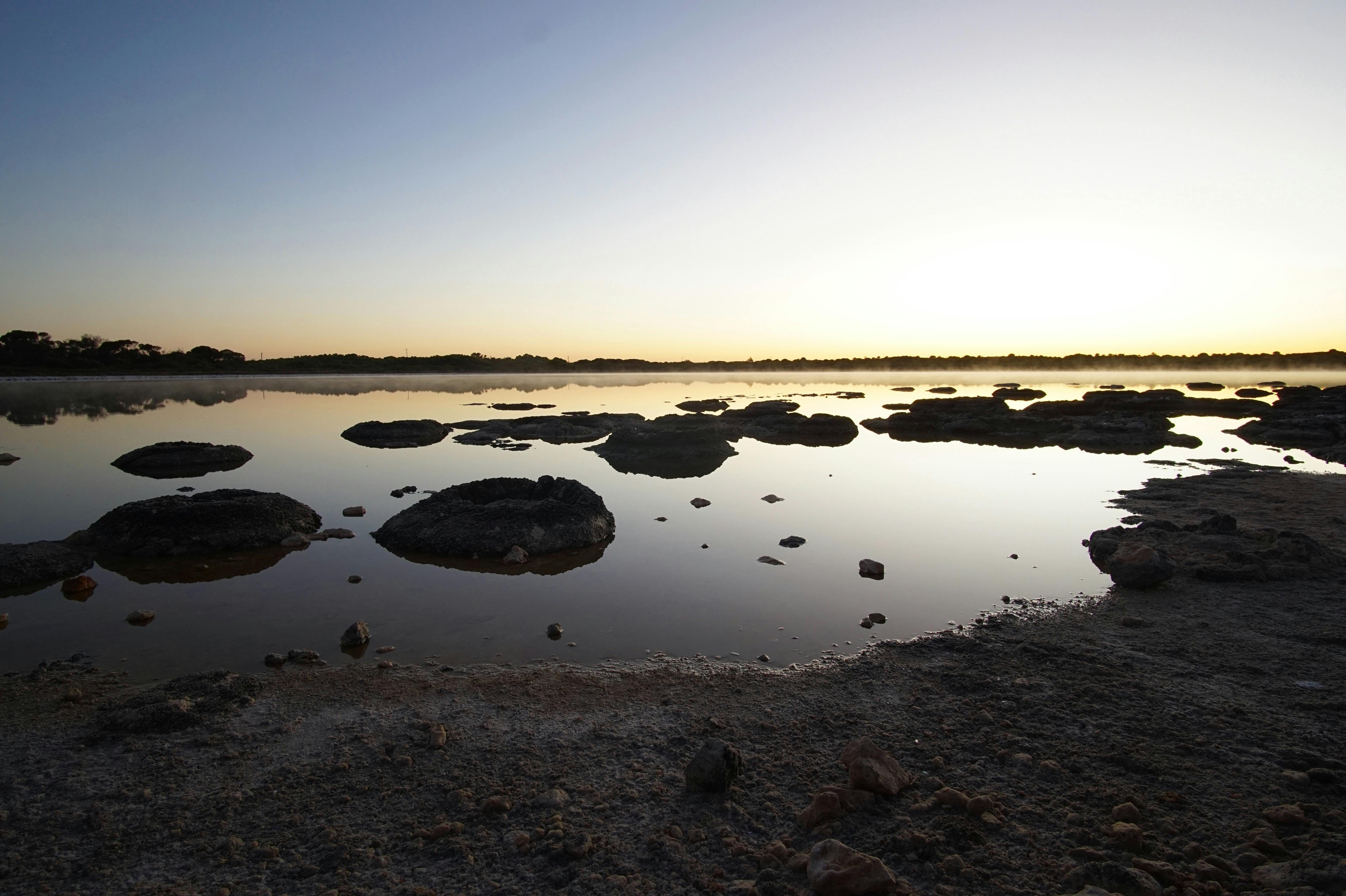 Stomalites at sunrise, a group of ancient rocks semi submerged in a lake