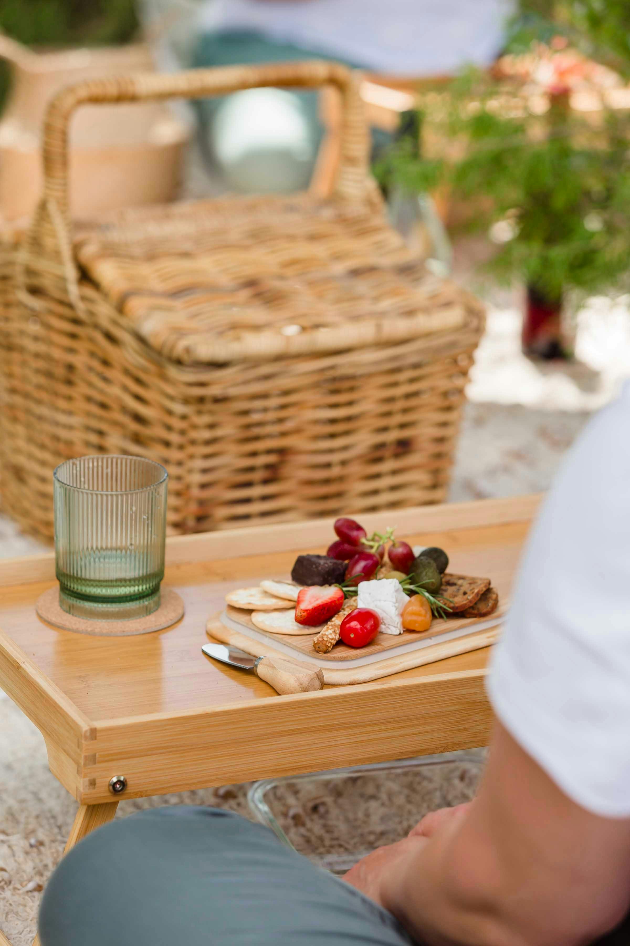 Picnic table with food and  cup