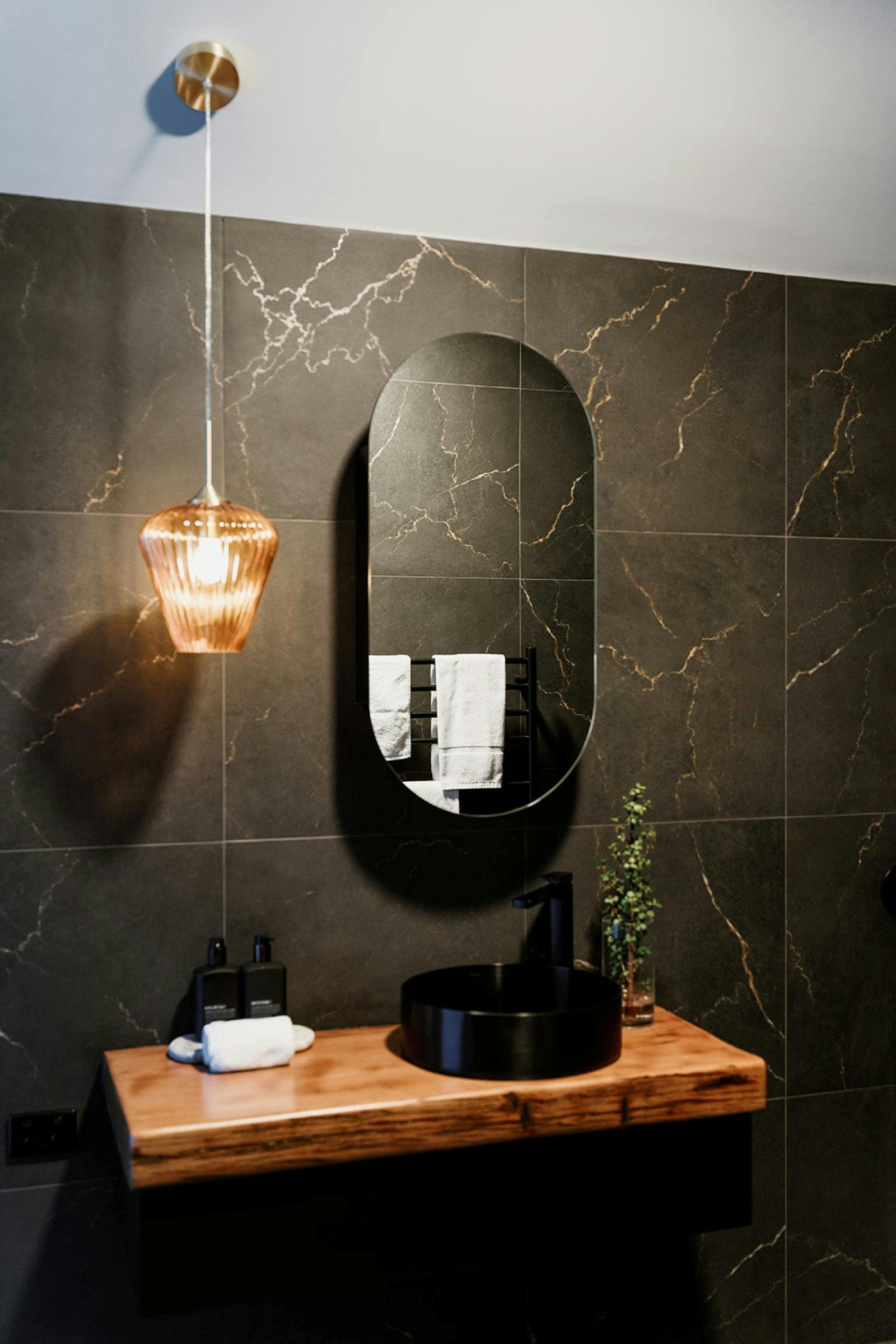 bathroom with a sink and a hanging lamp