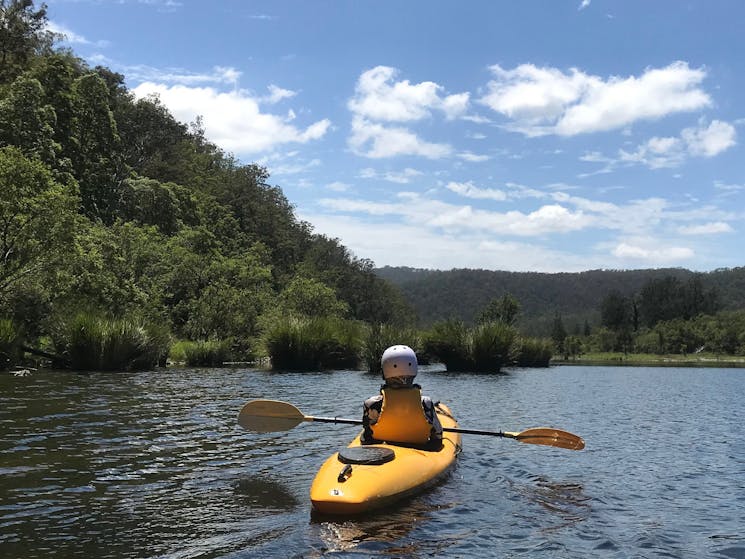 A lone Kayaker is drifting down the Nymboida River Trail looking at the spectacular river scenery.