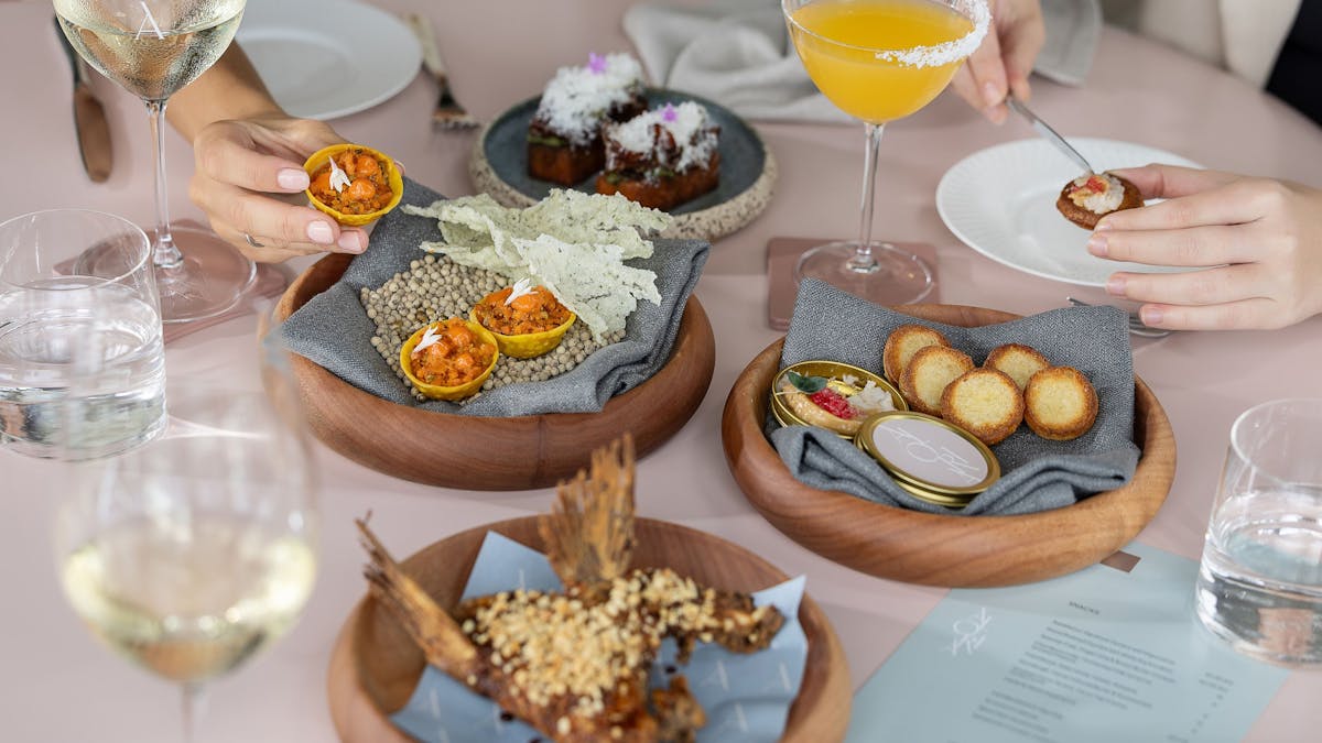 Plates of snacks and cocktails at Aloria