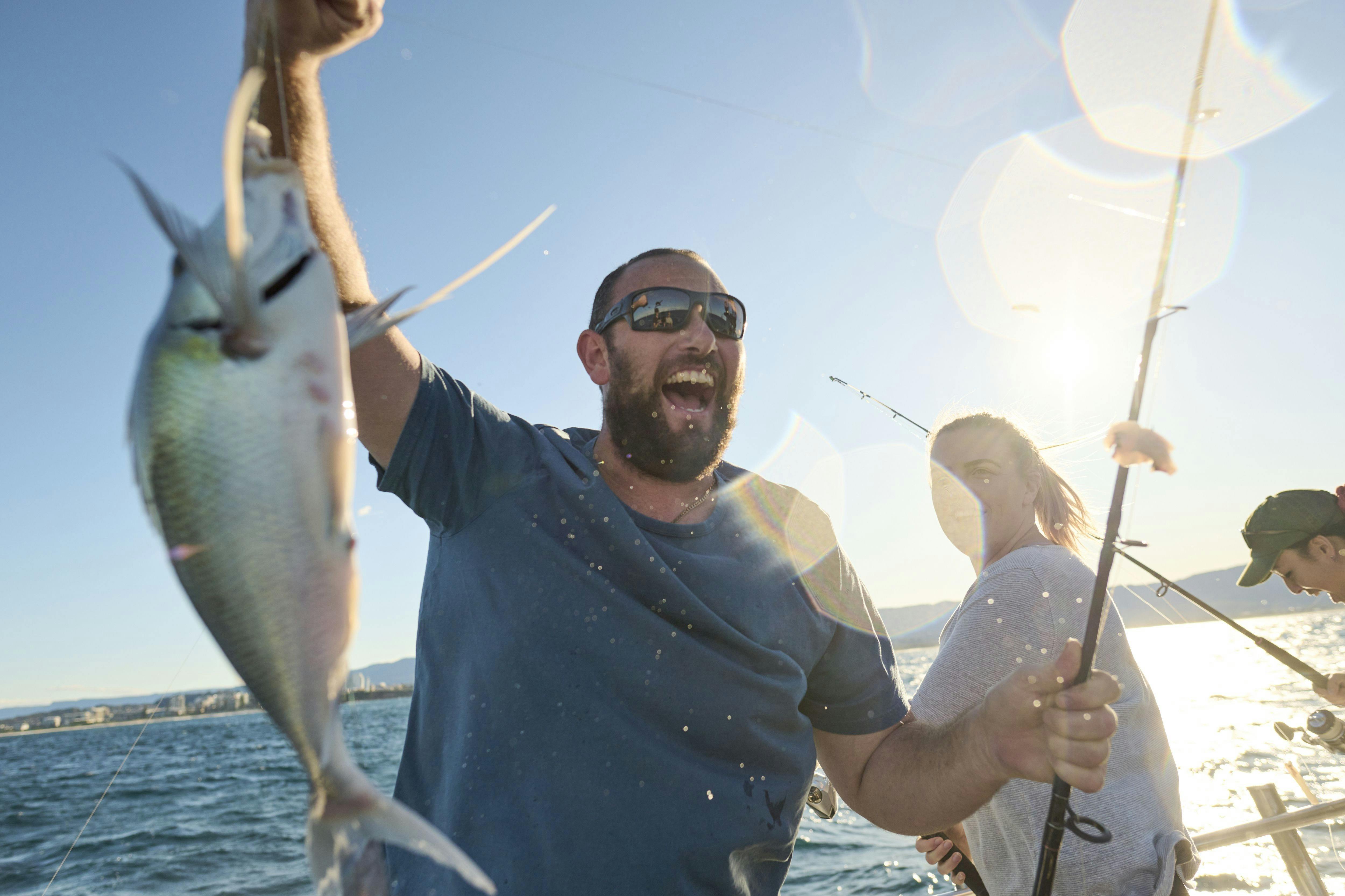 Male happy with a fish on the line