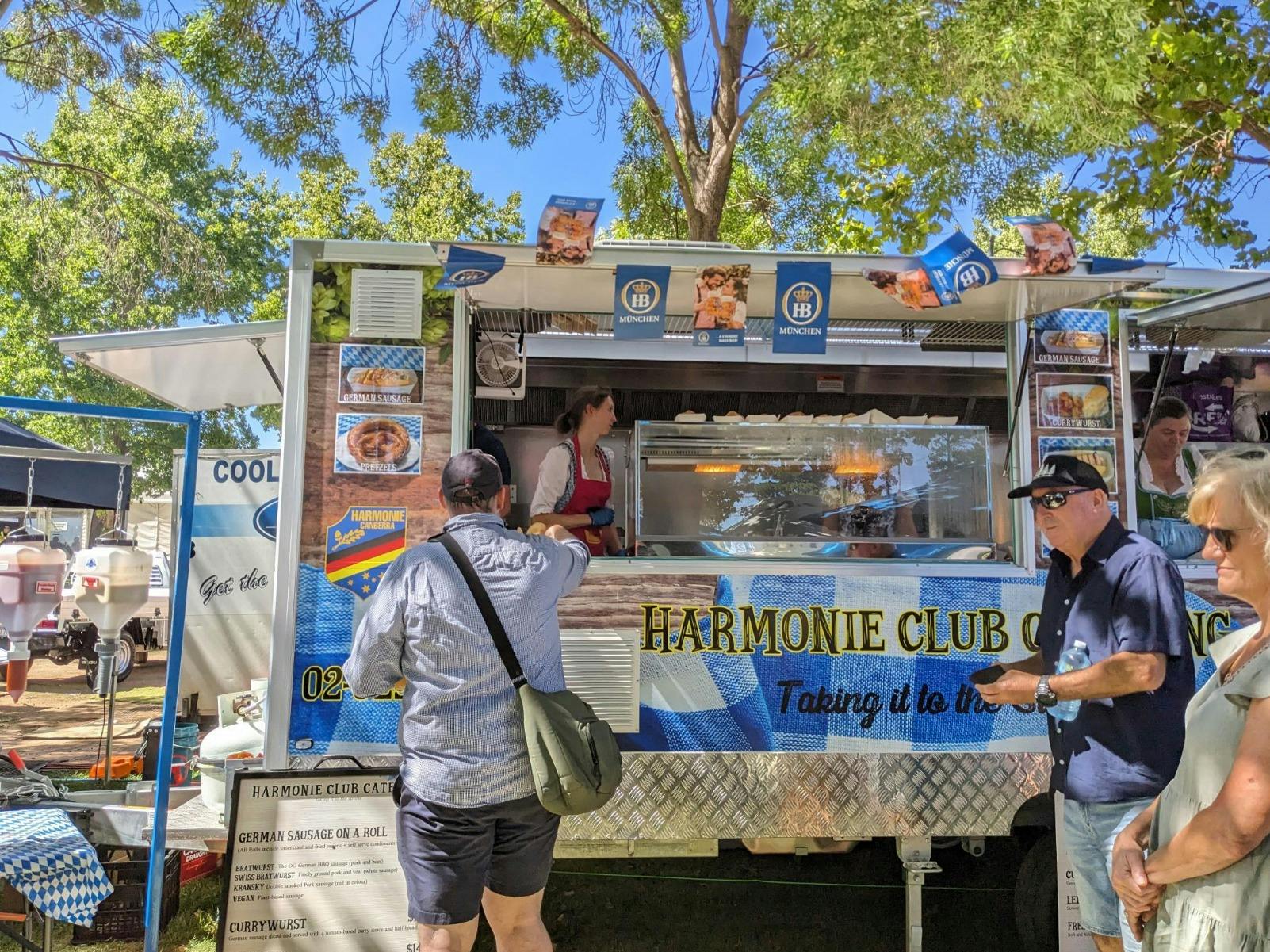 Image of food van serving people authentic German street food like bratwursts and kranskys
