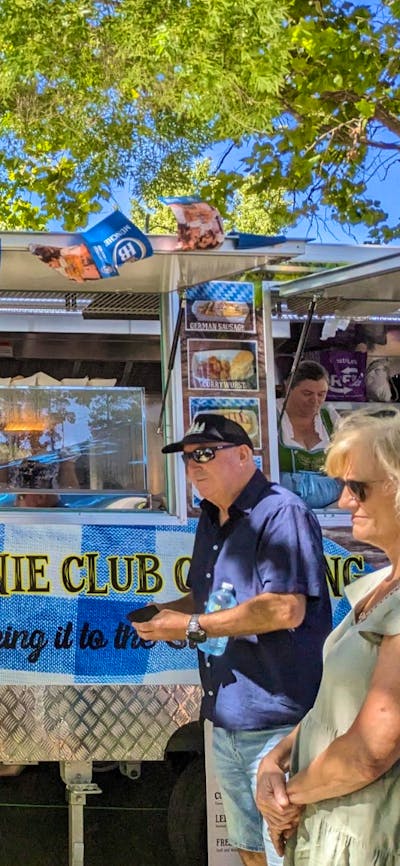 Image of food van serving people authentic German street food like bratwursts and kranskys