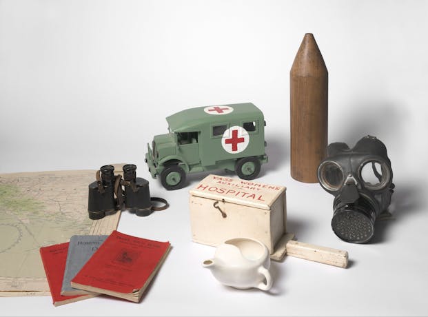 Objects including gas mask, replica ambulance, documents, map and binoculars