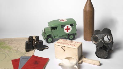 Objects including gas mask, replica ambulance, documents, map and binoculars