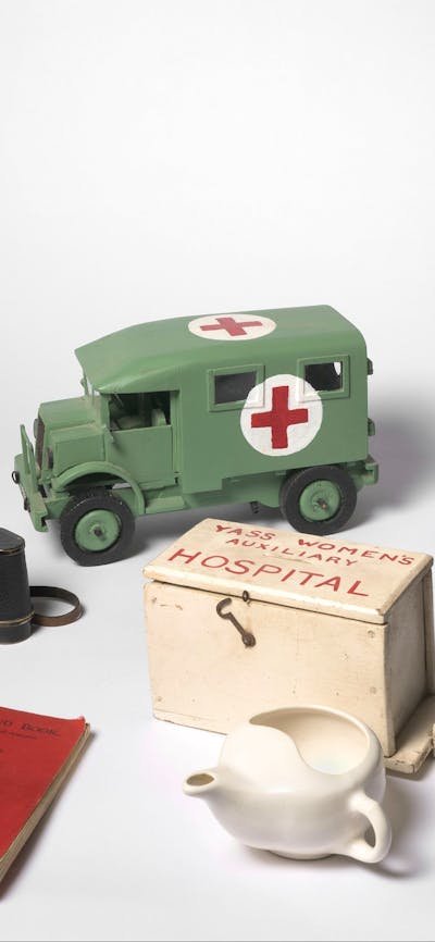 Objects including gas mask, replica ambulance, documents, map and binoculars