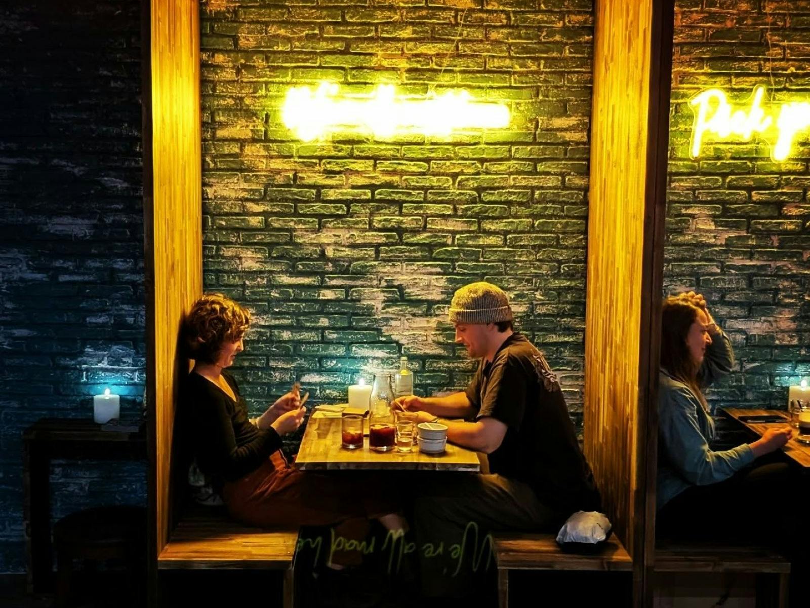 two people dining in a booth at Jekyll & Hyde