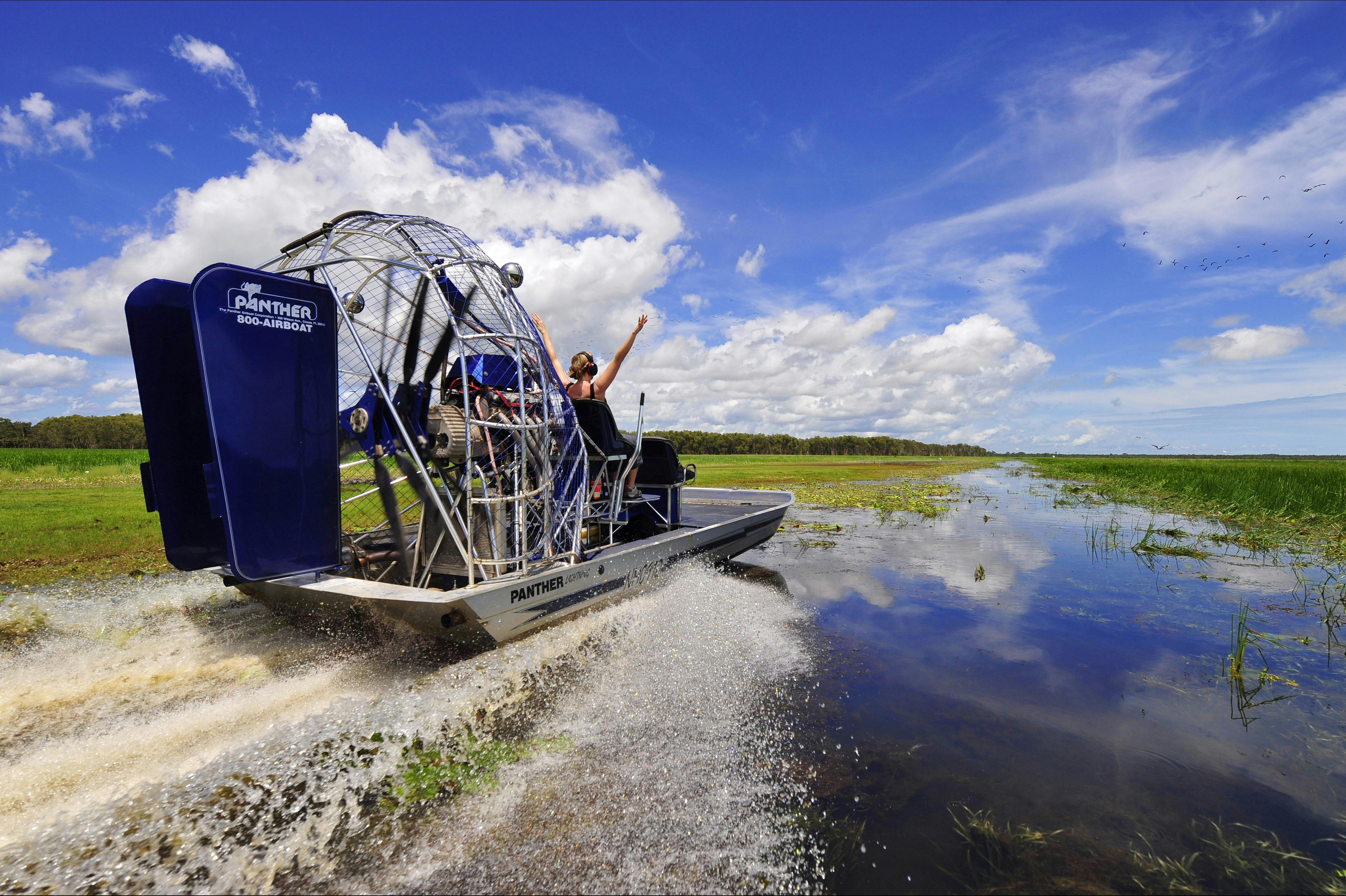 Action shot of people air boating down Mary River